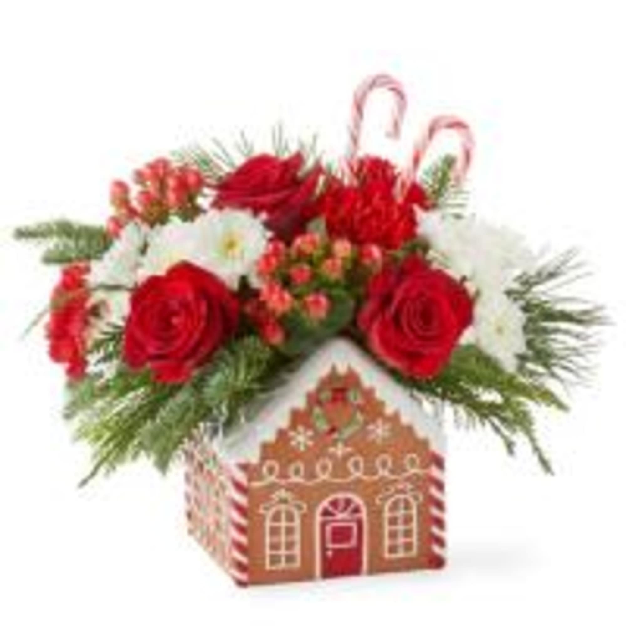 Classic Gingerbread house filled with Christmas greens, red roses, white mums, red