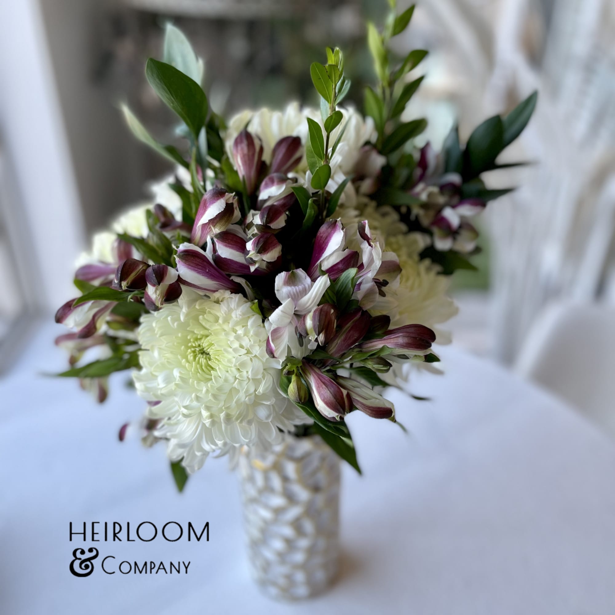 A lovely white honey comb cylinder with gold accents filled with the