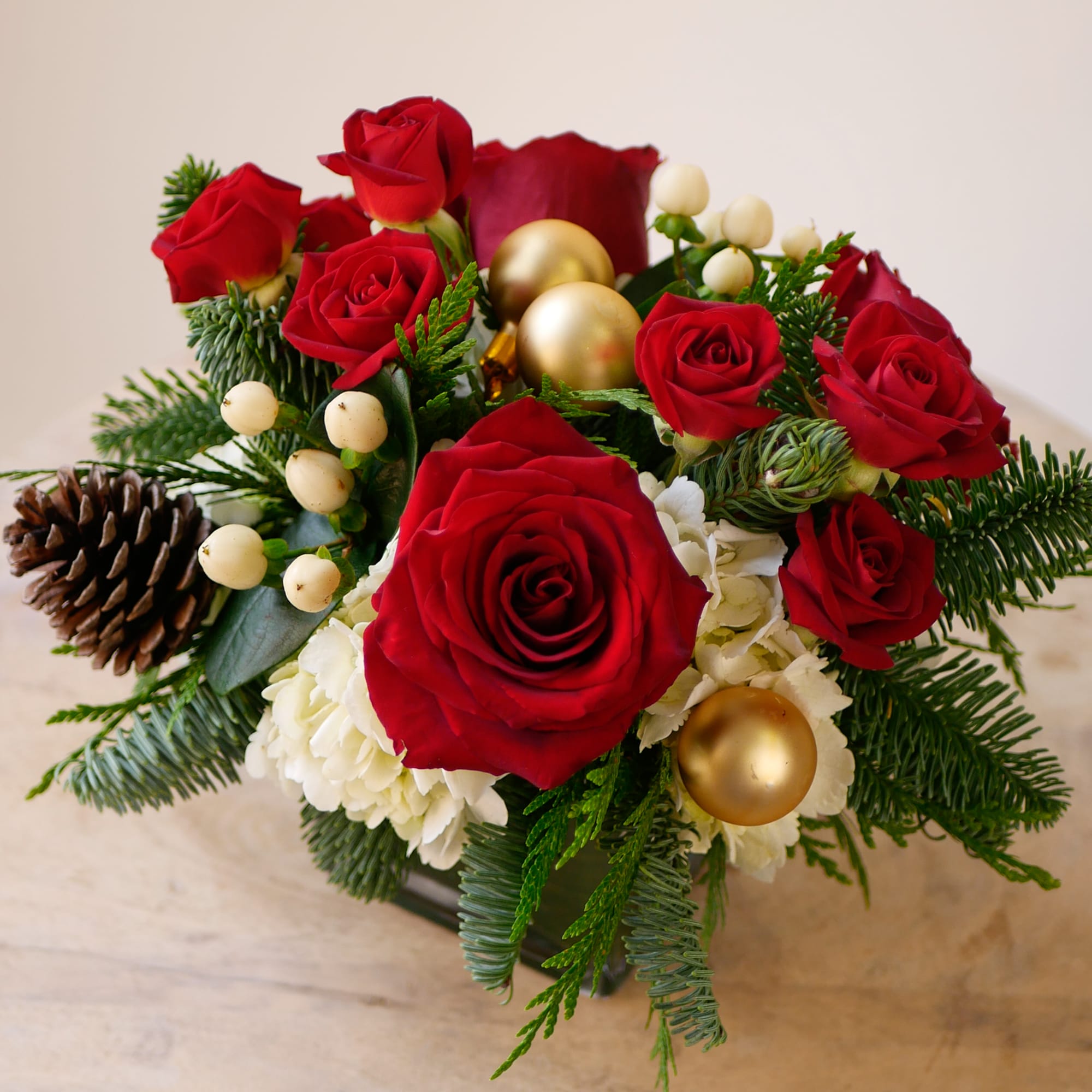 Celebrate the season with this petite holiday floral arrangement featuring premium red