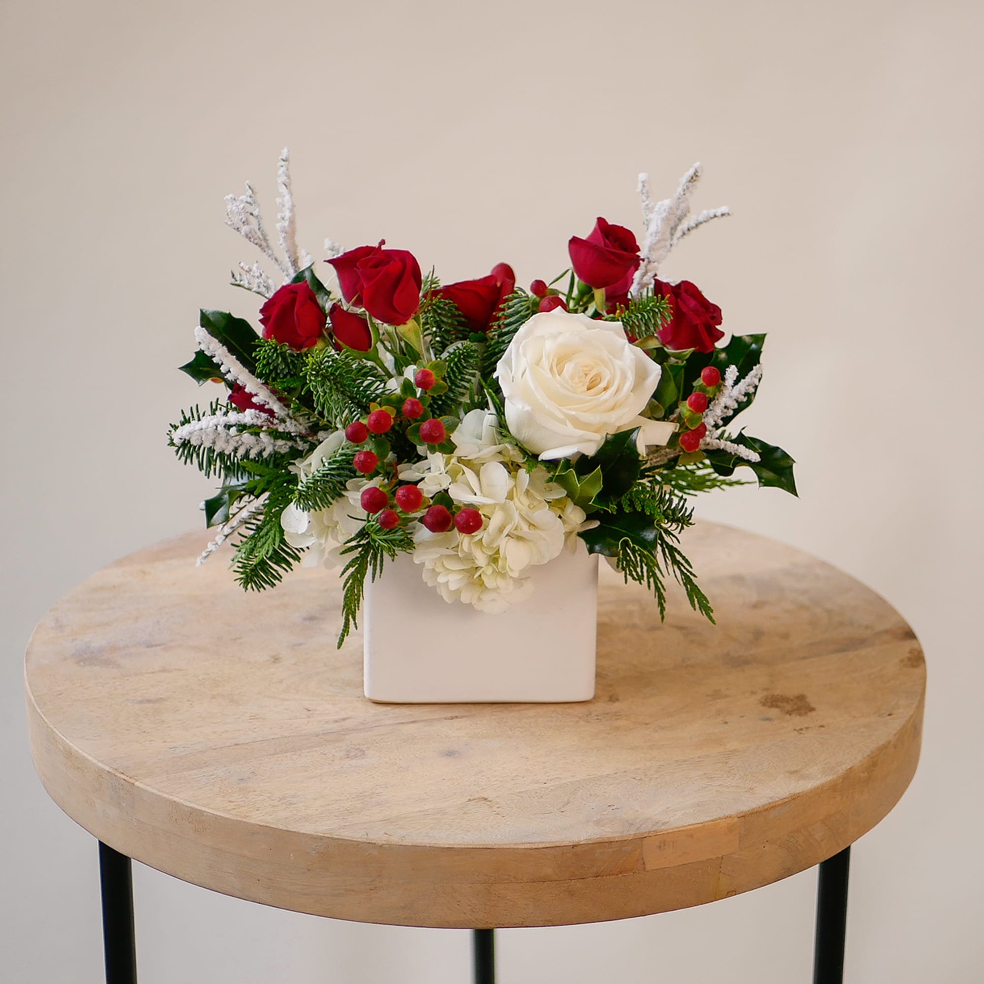 This Christmas-inspired floral arrangement features the same elegant mix of premium white