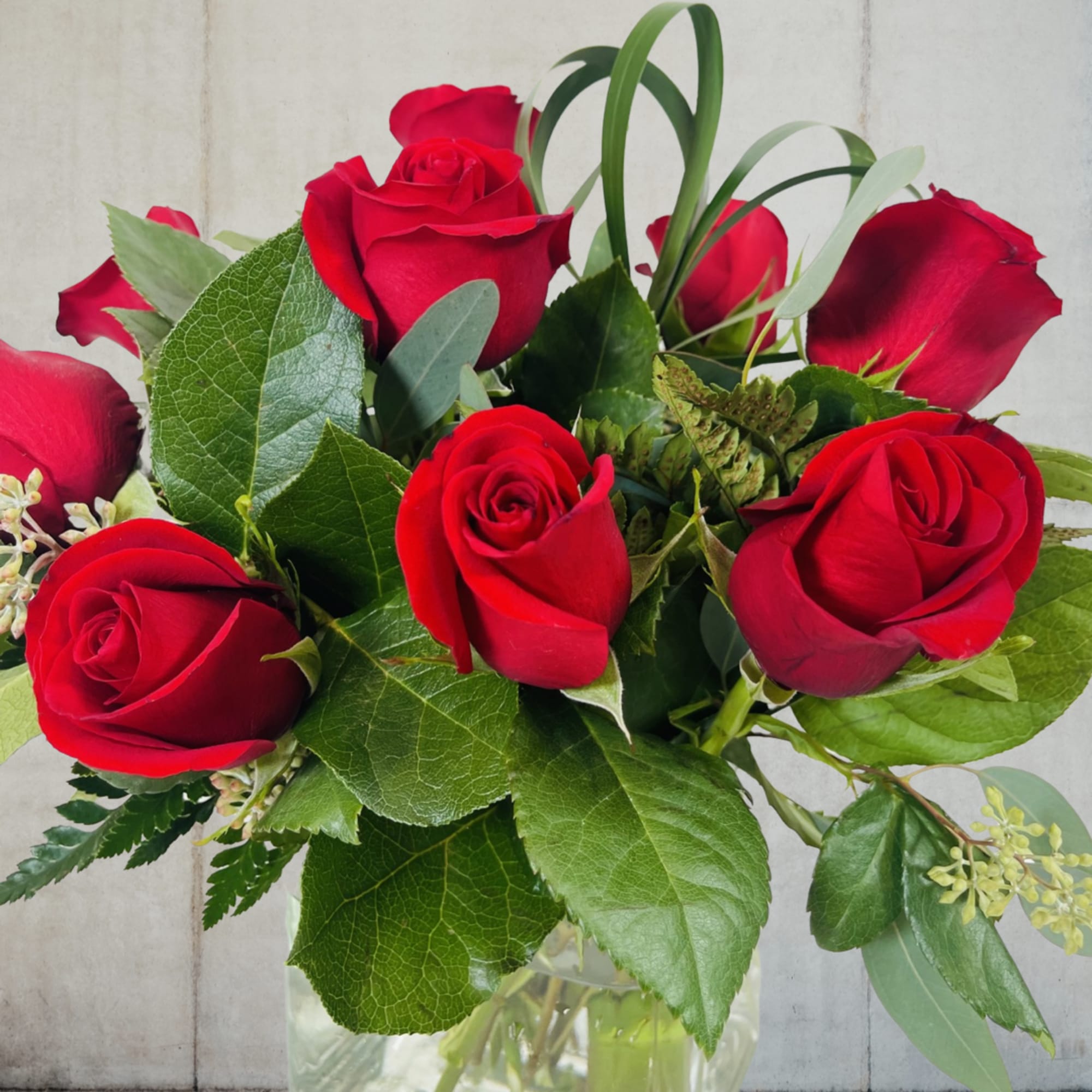 Surprise your special someone with a charming cube of 12 vibrant roses