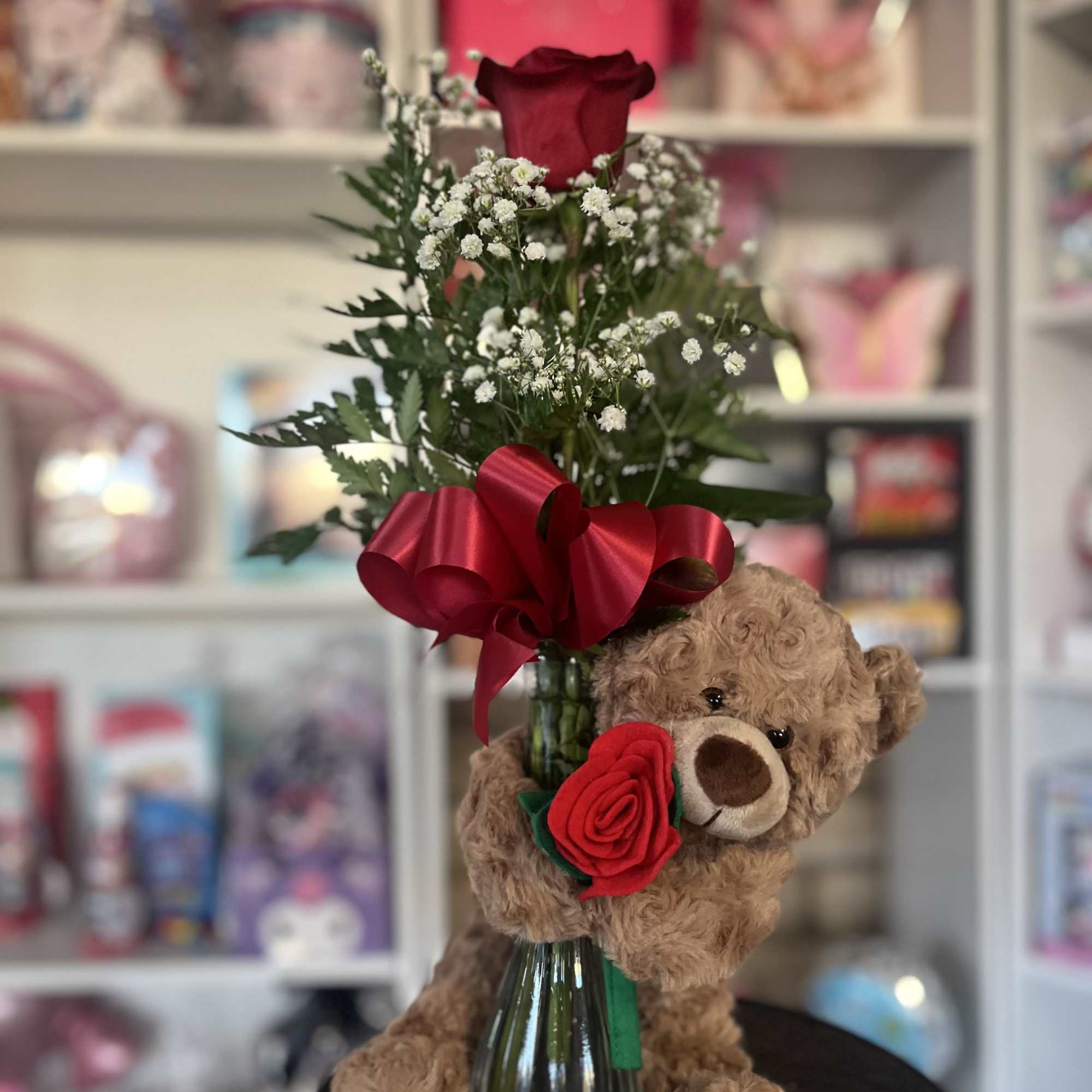 fresh rose in bud vase with floral bear 