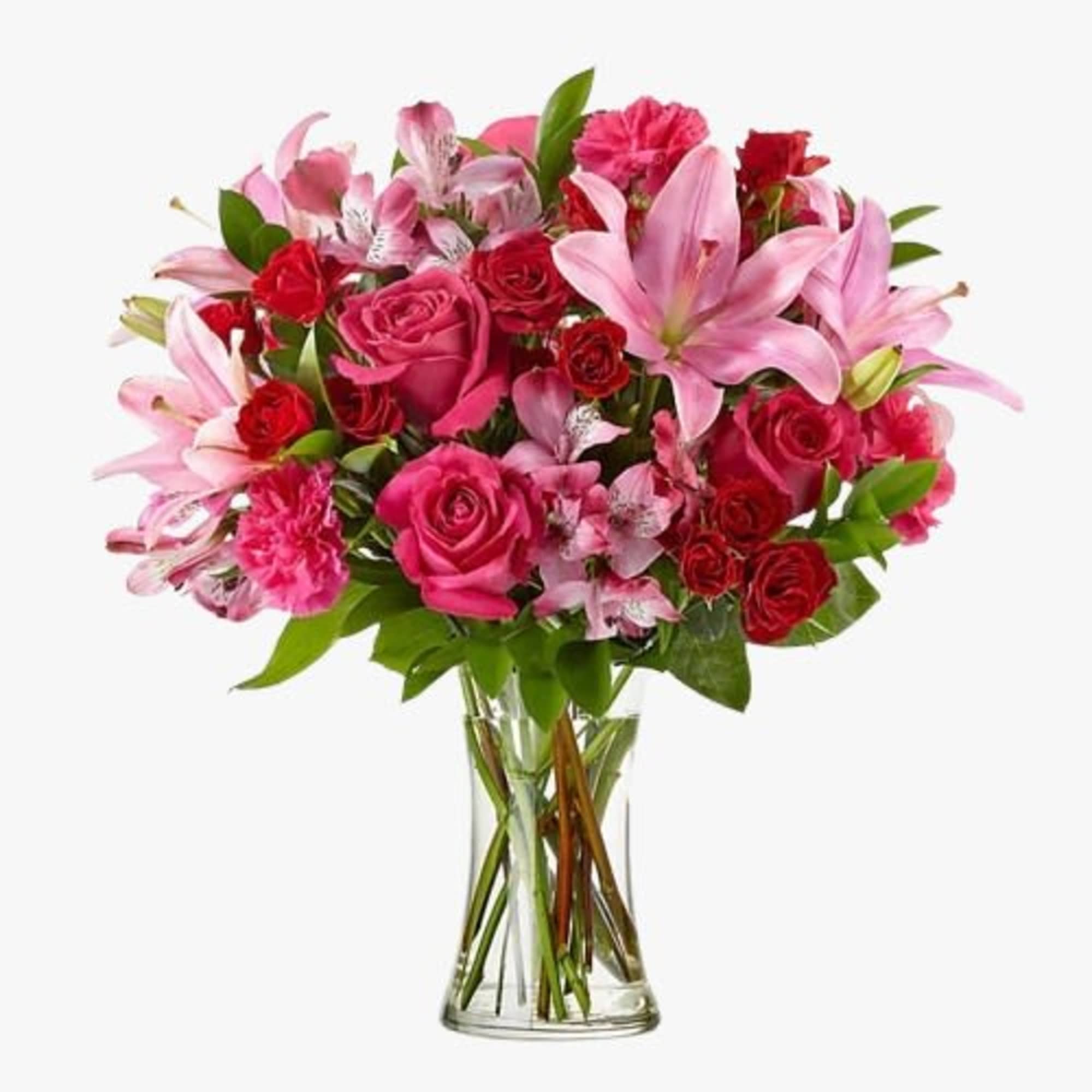 Captivating arrangement in a vase, featuring pink lilies, hot pink roses, carnations