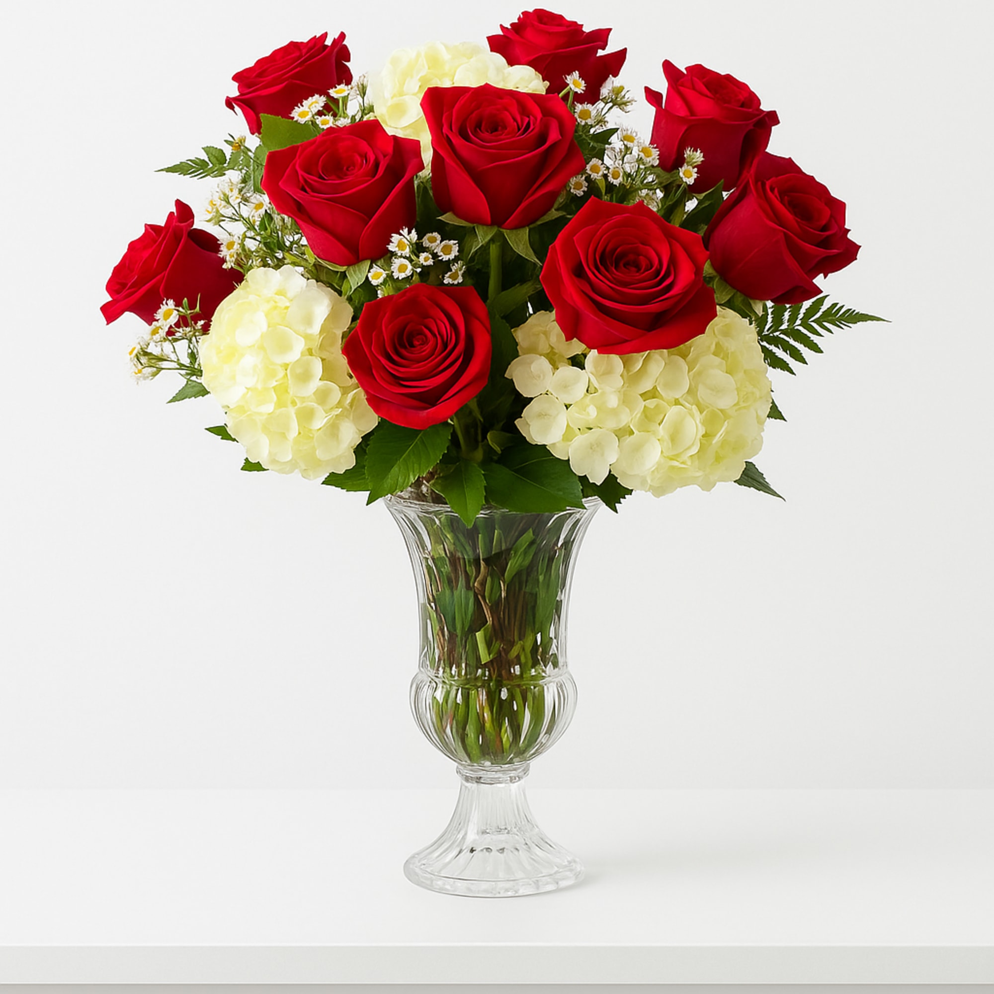 This stunning arrangement features one dozen premium red roses, beautifully complemented by