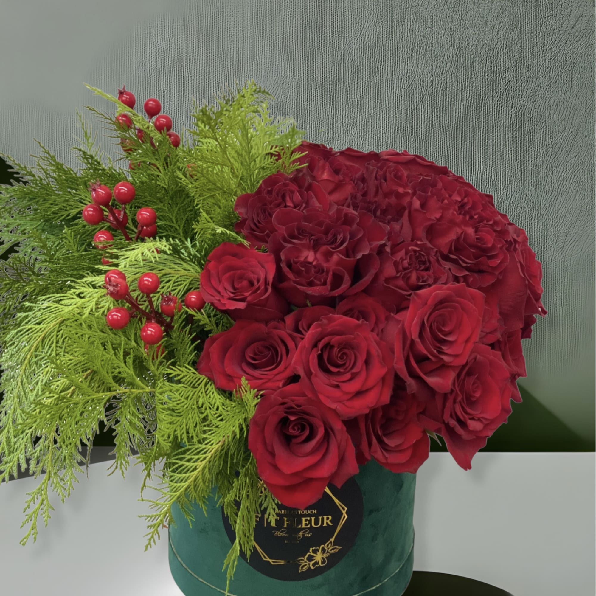 This arrangement arrives in a Hat box with fresh red roses, artificial