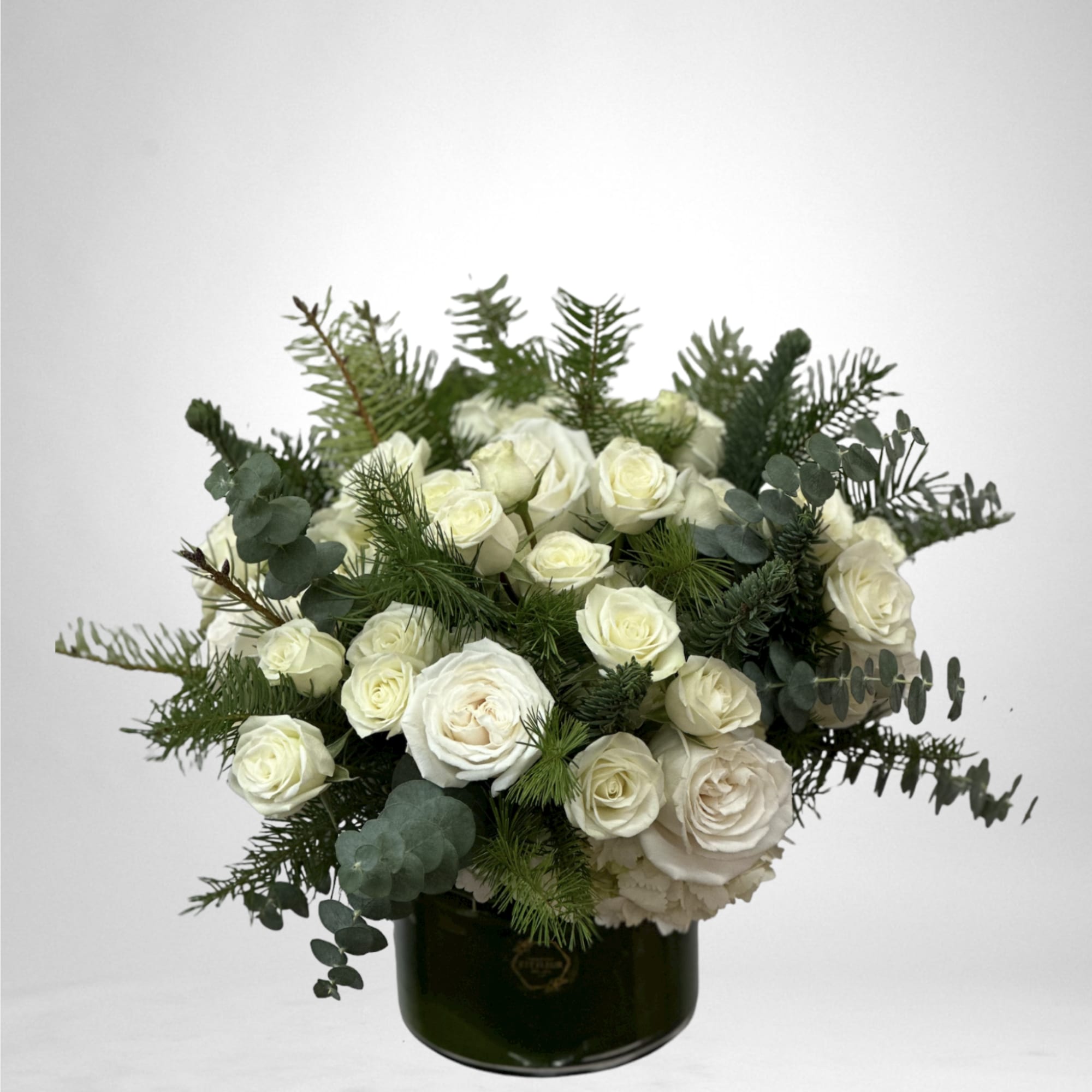 This arrangement comes in a glass round vase, with roses, hydrangea and
