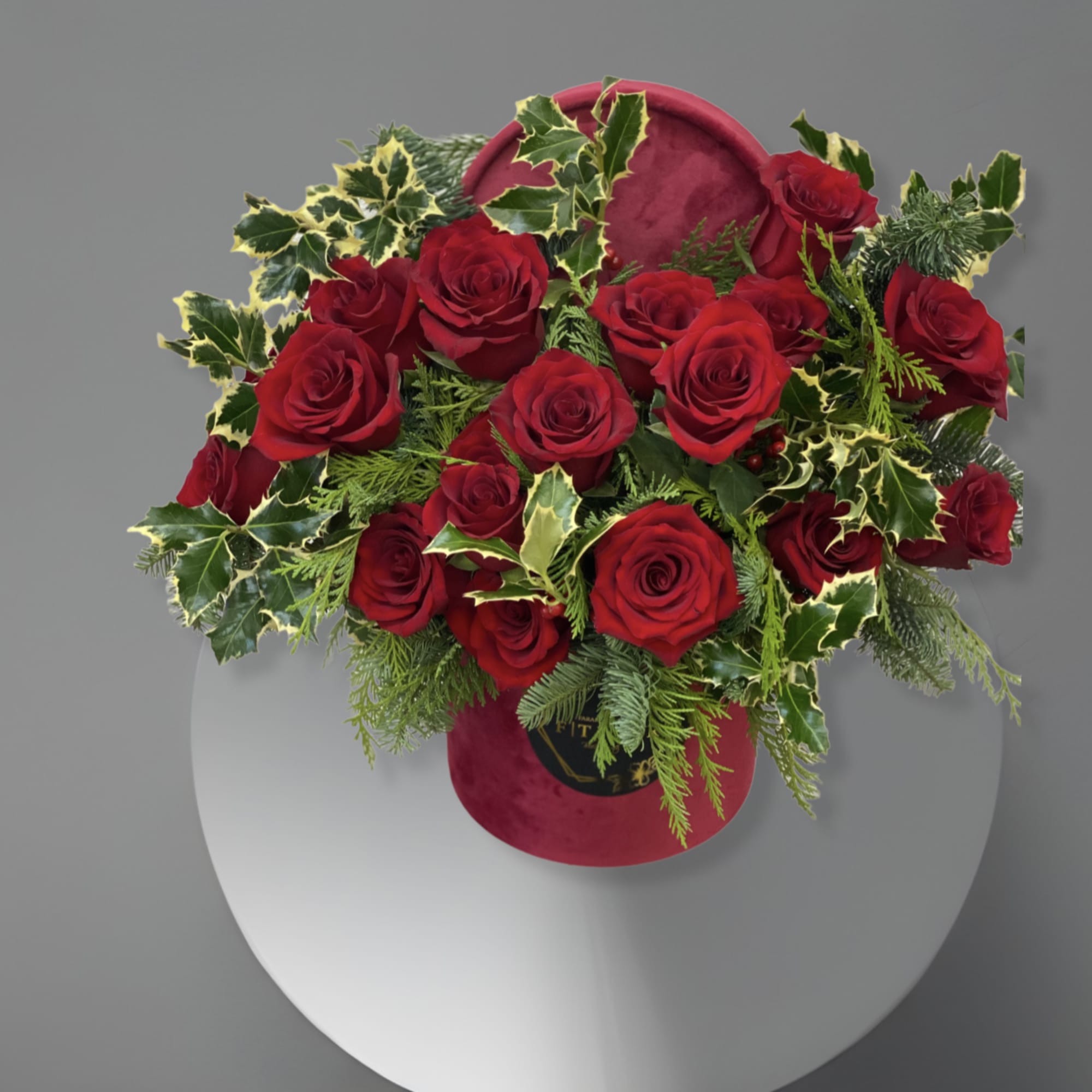 This arrangement comes in a Hat box with beautiful red roses and