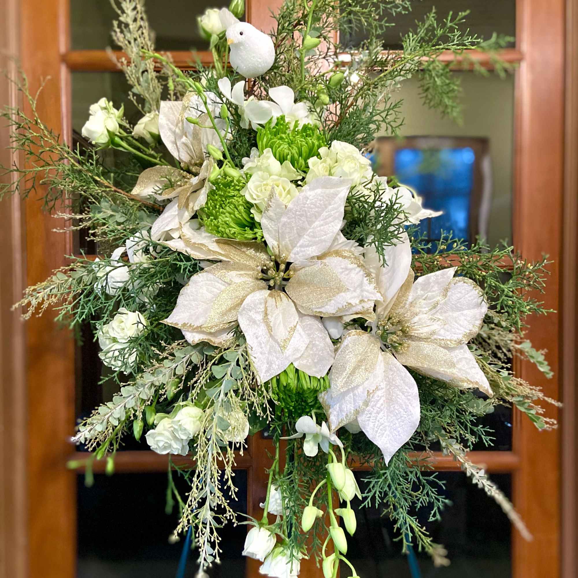 Seasonal florals and greenery reach towards the heavens to memorialize your loved