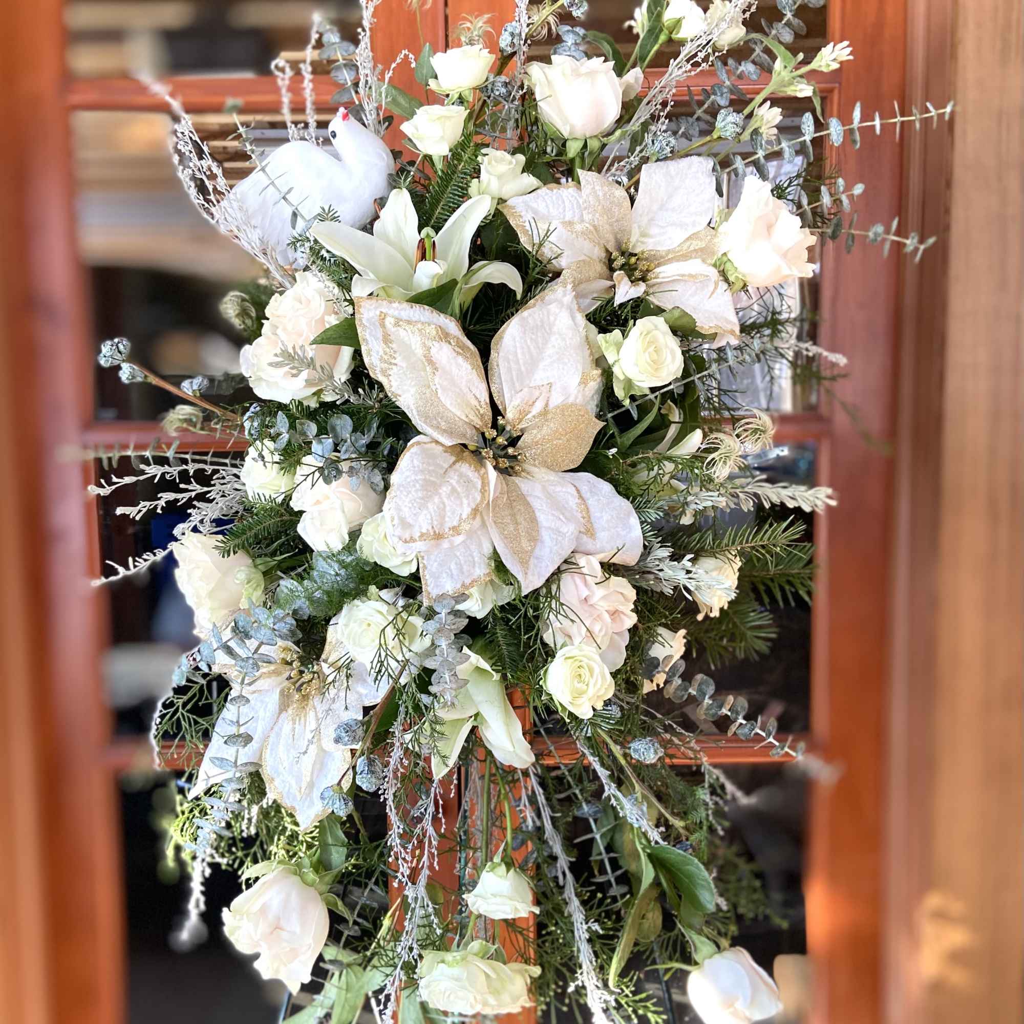Seasonal florals and greenery reach towards the heavens to memorialize your loved