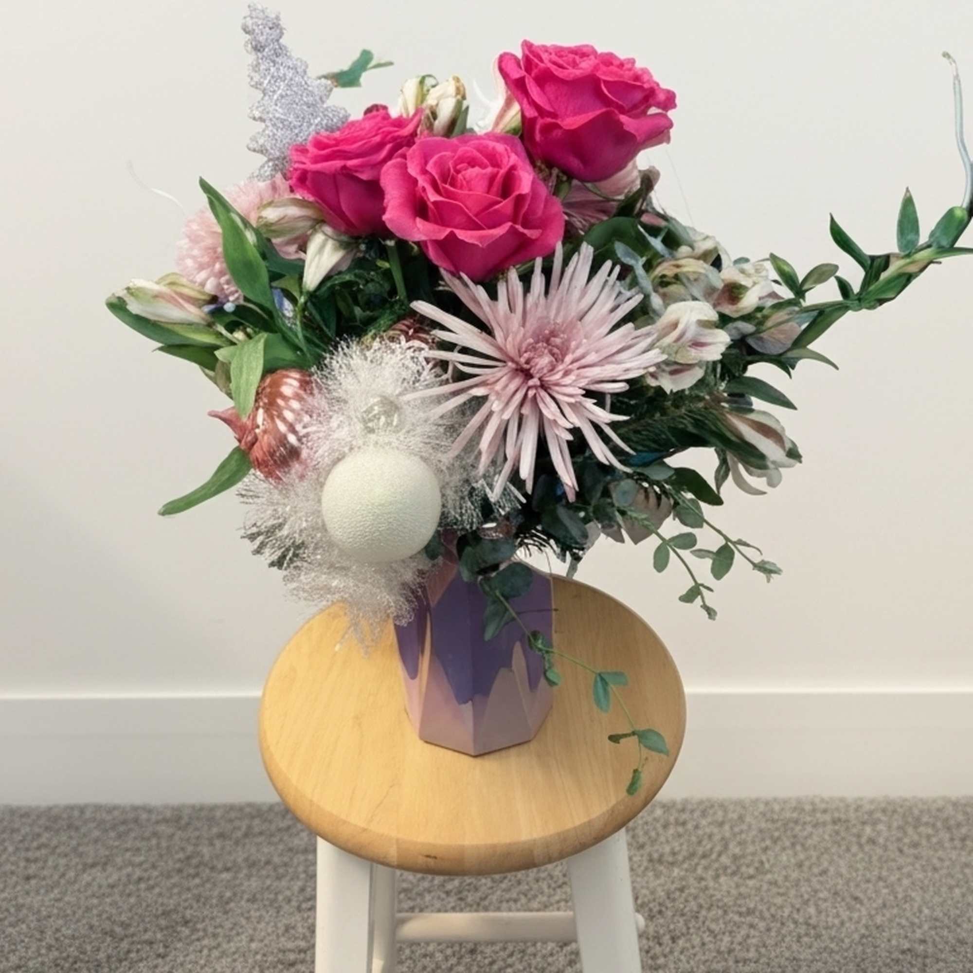 A pink frosty twist on the tradition Christmas arrangement. Perfect for that