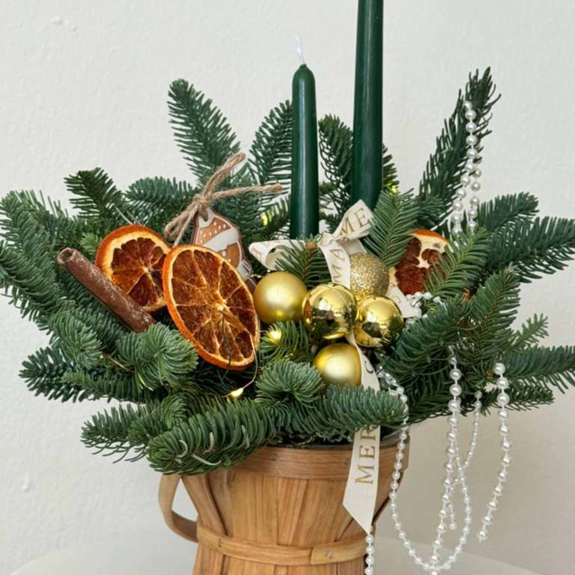 A cozy holiday centerpiece made with fresh fragrant evergreen, paired with tall