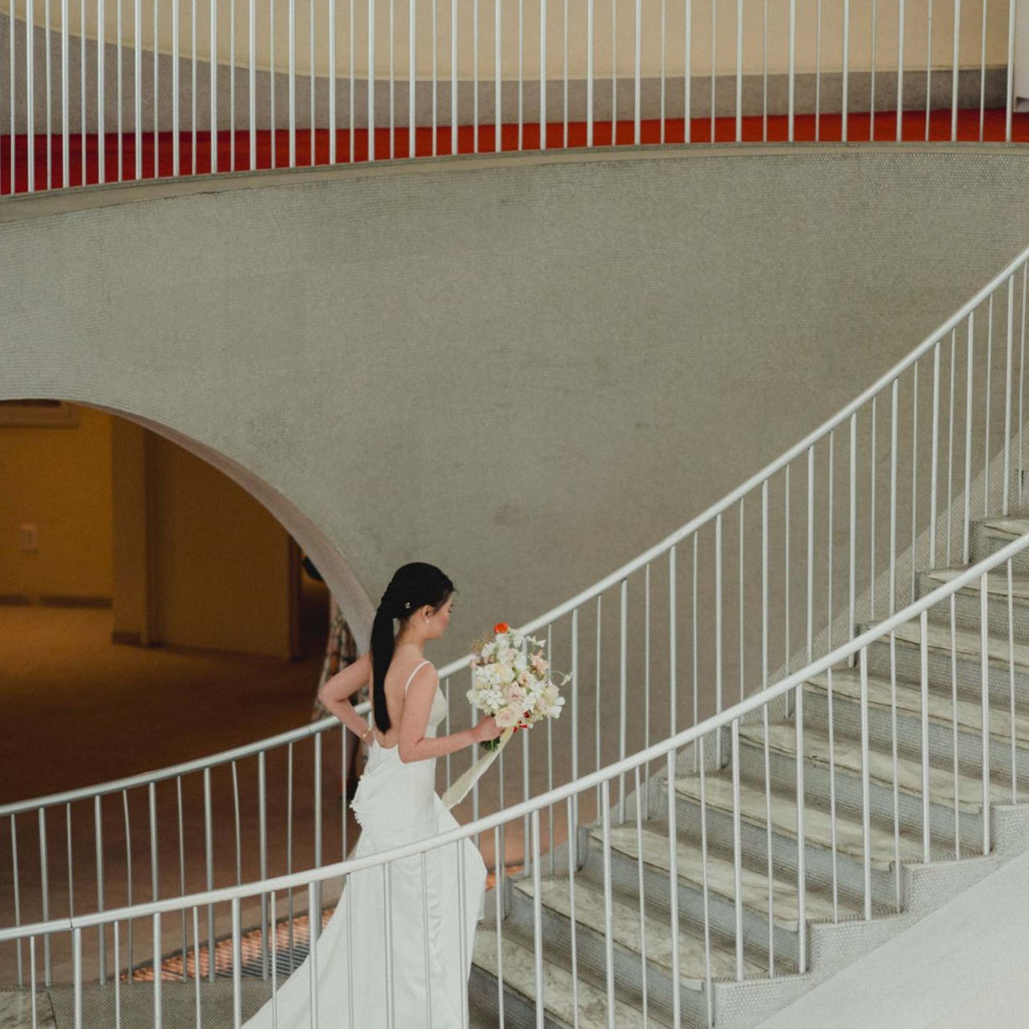 A large-scale bridal bouquet featuring elegant orchids and premium roses, designed in