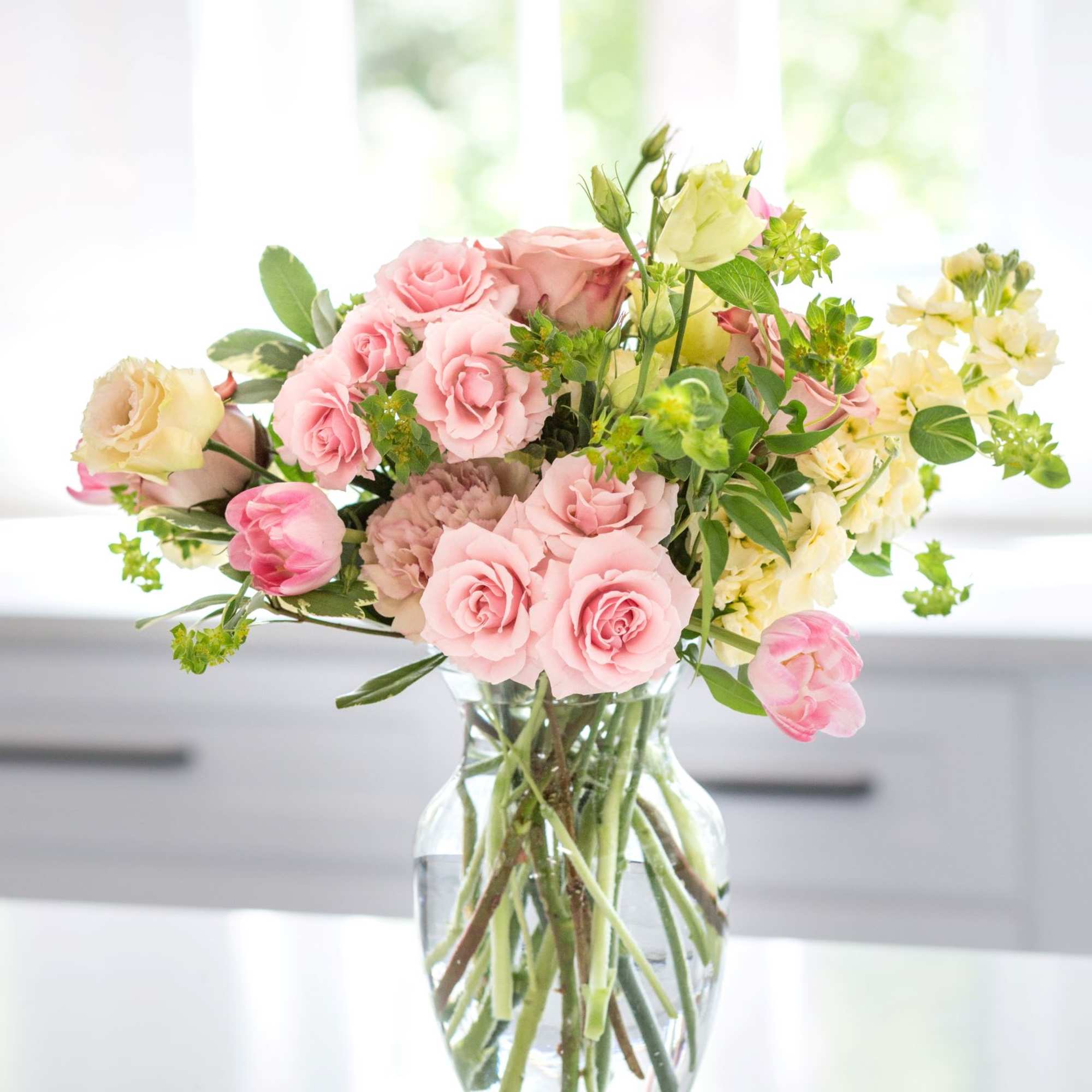 A bold and elegant floral arrangement designed in rich red and soft