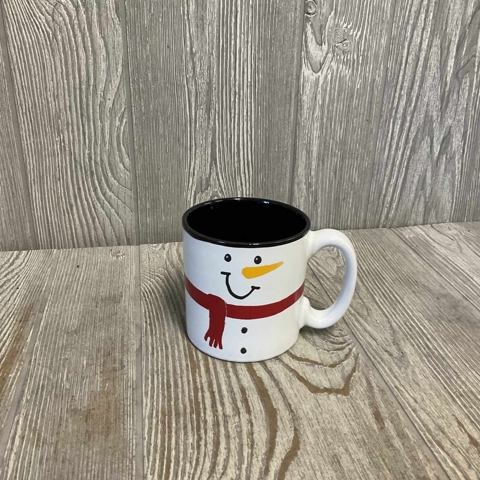 Fresh cut flowers arranged in a keepsake ceramic snowman mug! Includes a