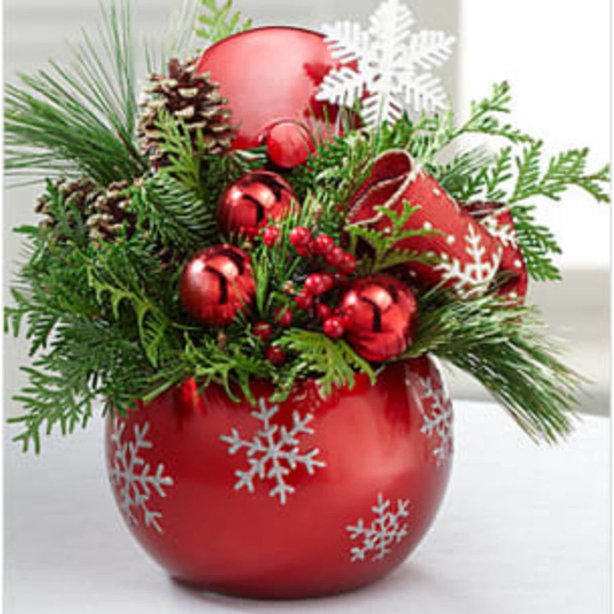 A festive Christmas floral arrangement designed with fragrant holiday greens, accented with