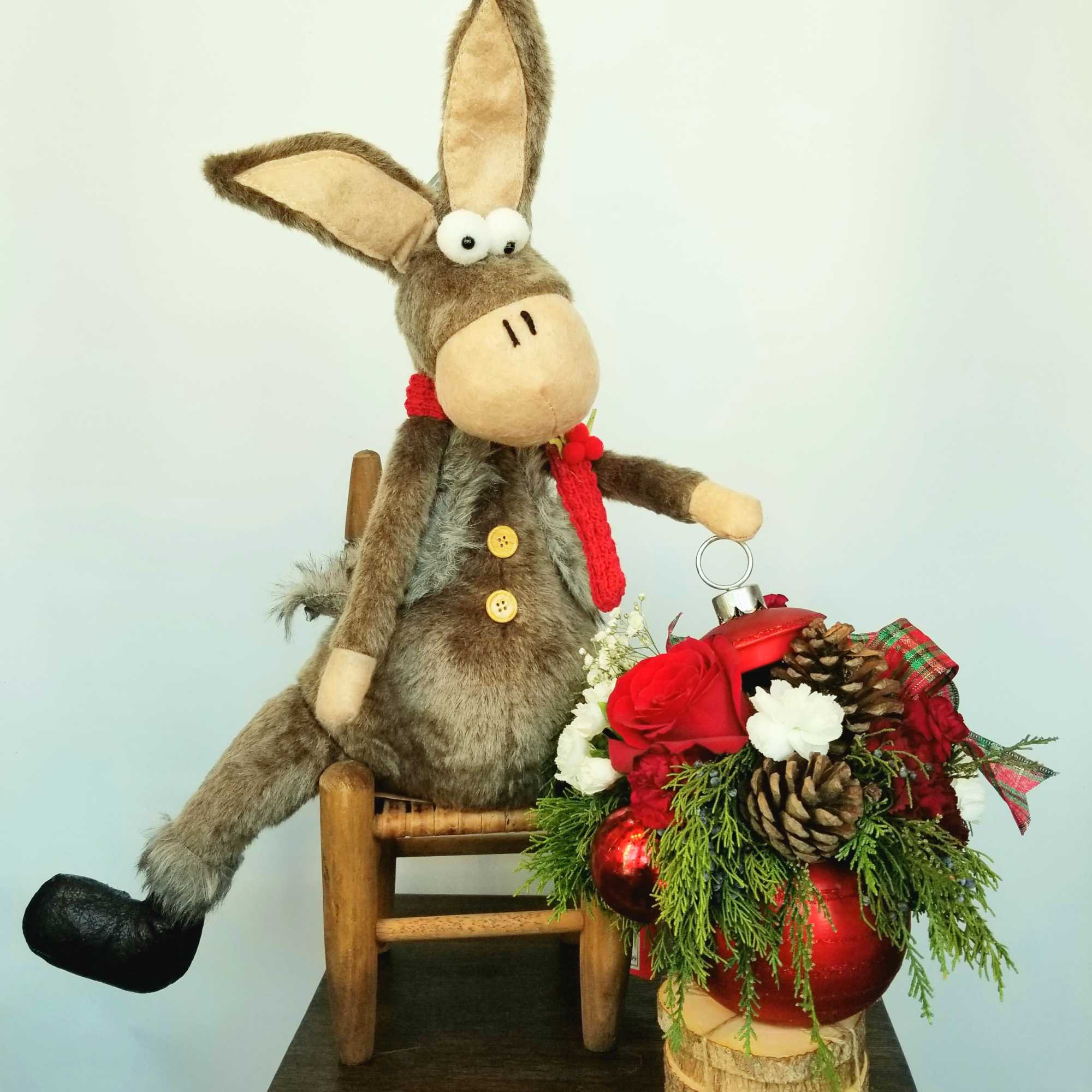 A festive Christmas floral arrangement designed with fragrant holiday greens, accented with