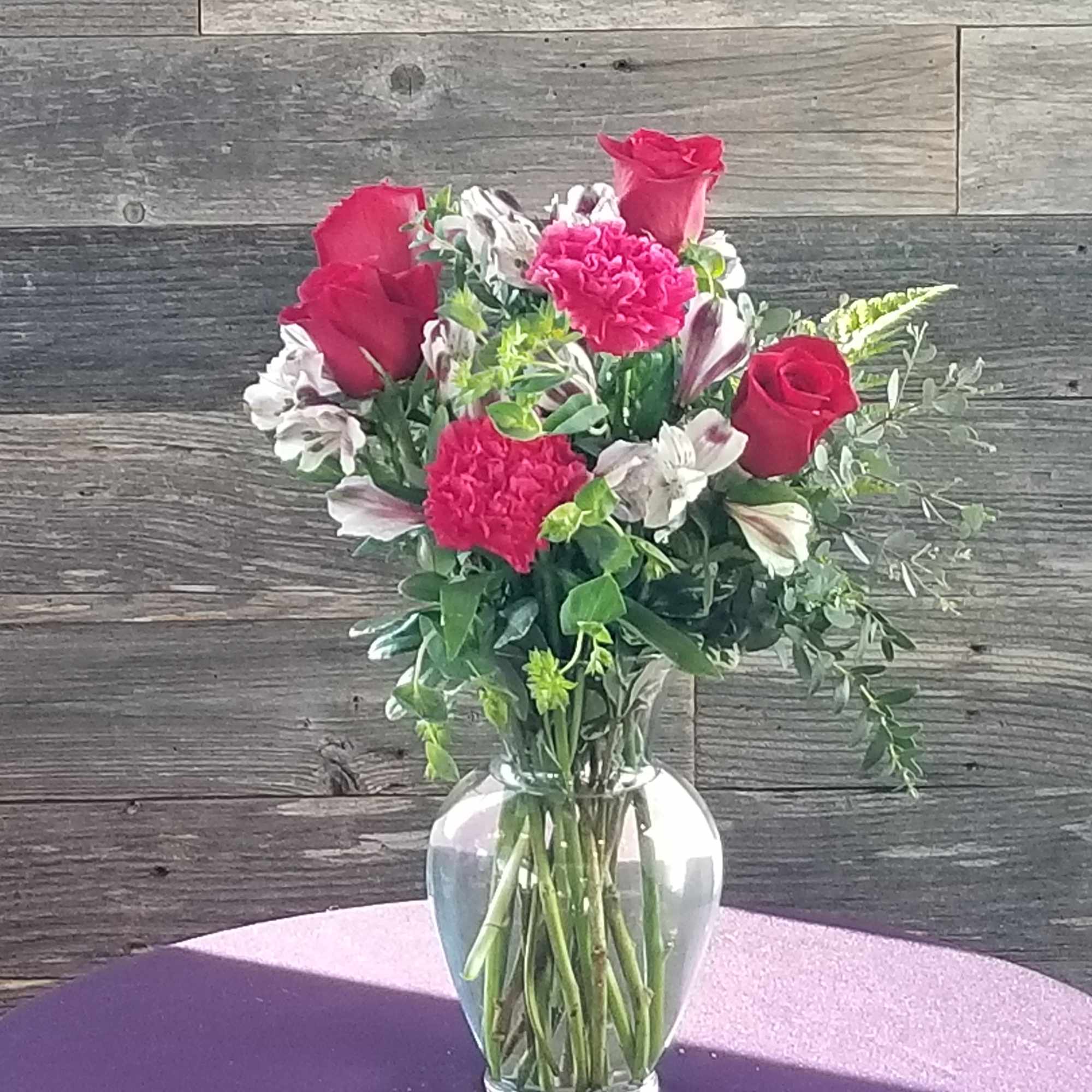   Roses, alstroemeria, and carnations  with trendy greenery.  

We