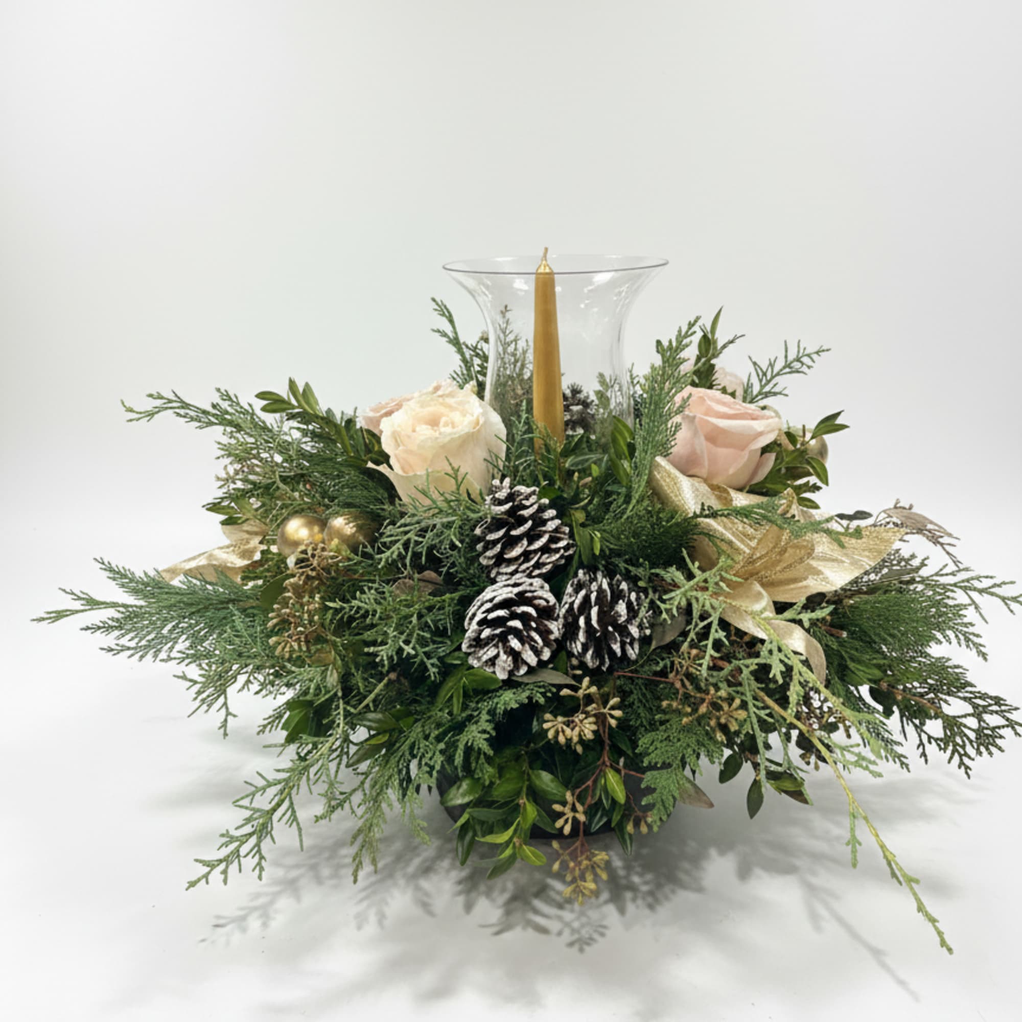 Golden Glow 
A warm, elegant arrangement of winter greens, soft blush roses