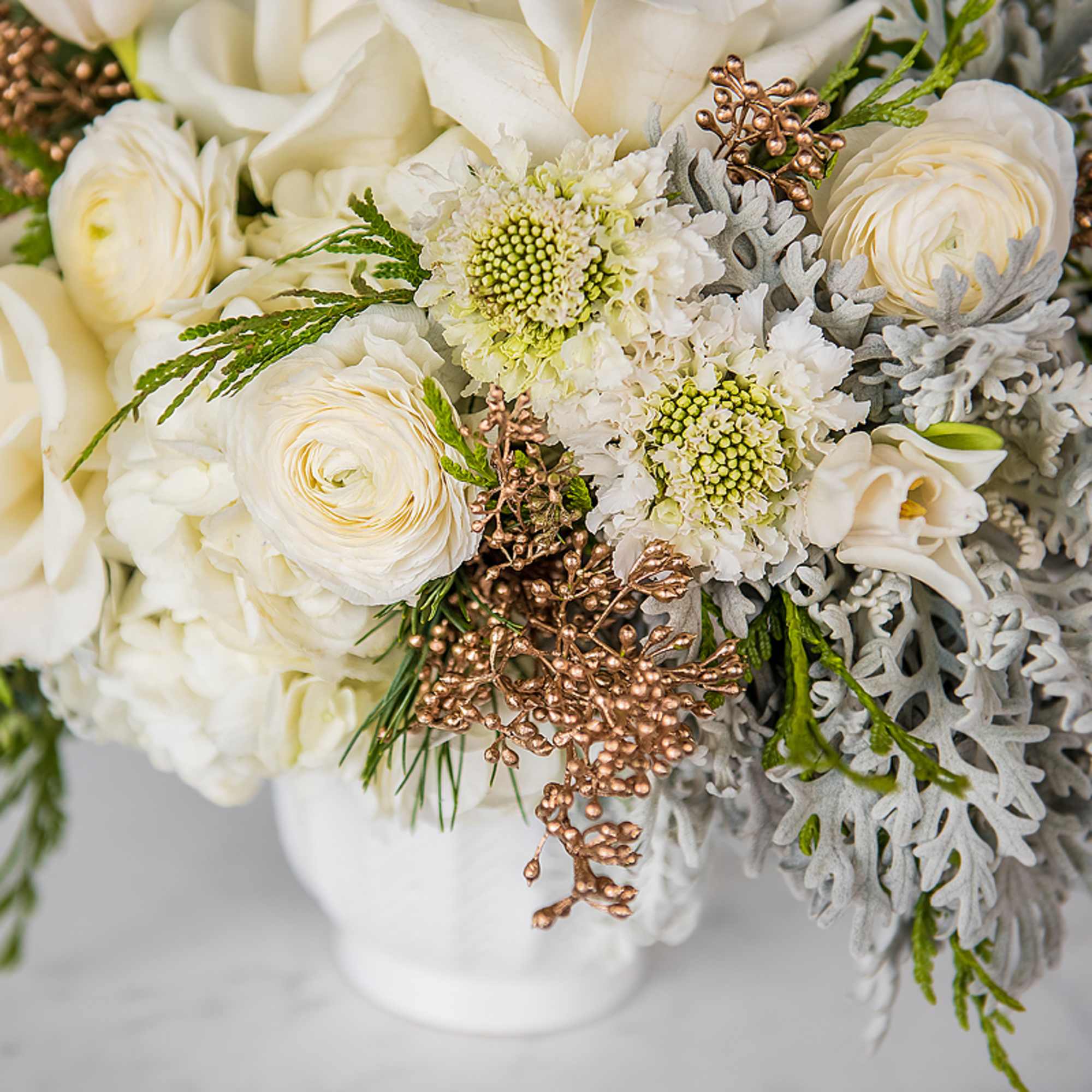 Soft, elegant, and comforting, Cozy Feels features white and cream seasonal blooms