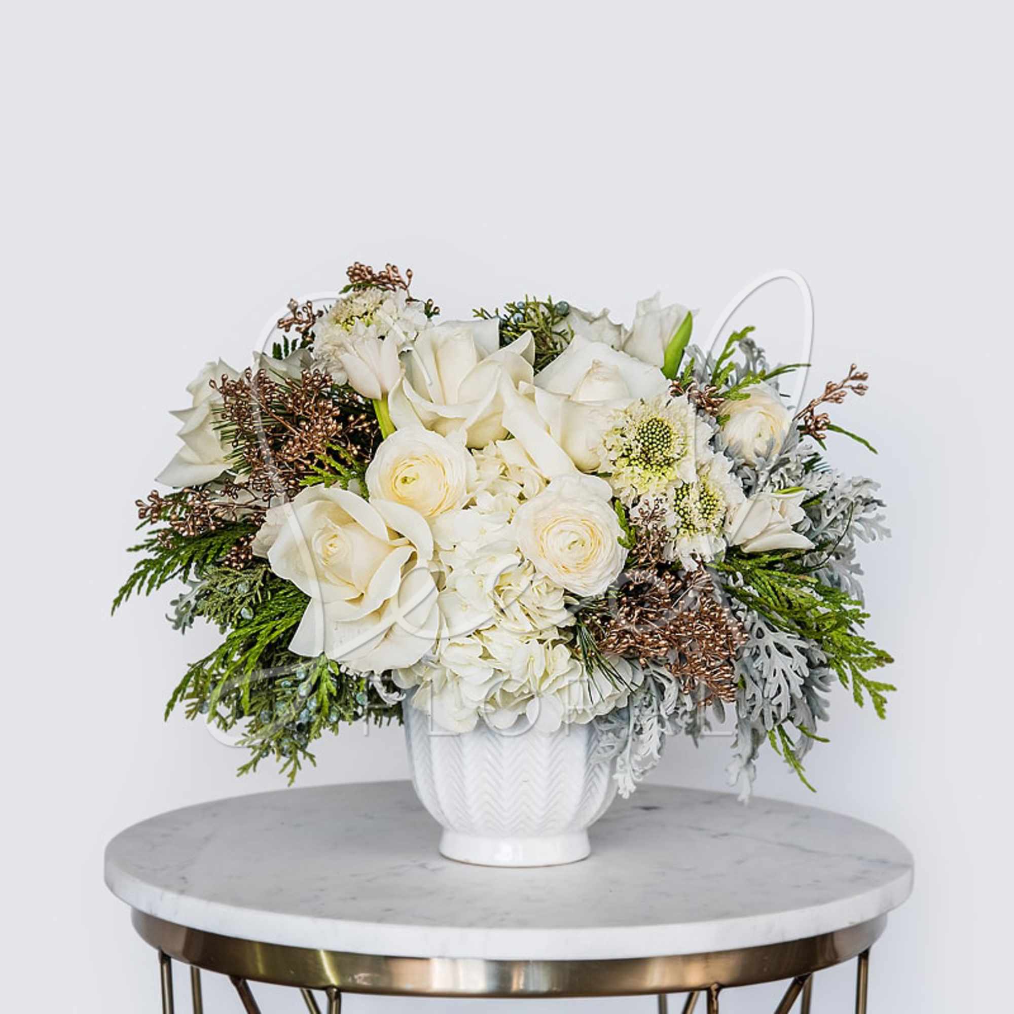 Soft, elegant, and comforting, Cozy Feels features white and cream seasonal blooms