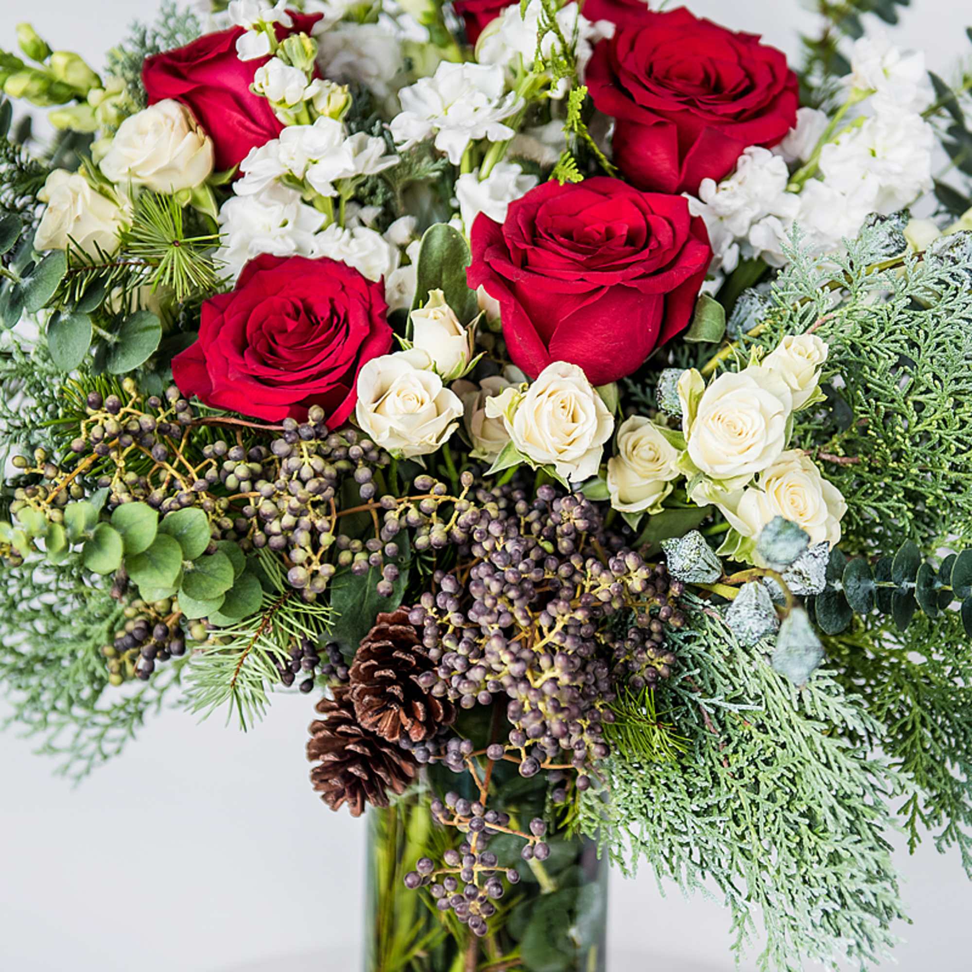 Celebrate the holidays with our Seasonal Holiday Arrangement, a lush mix of