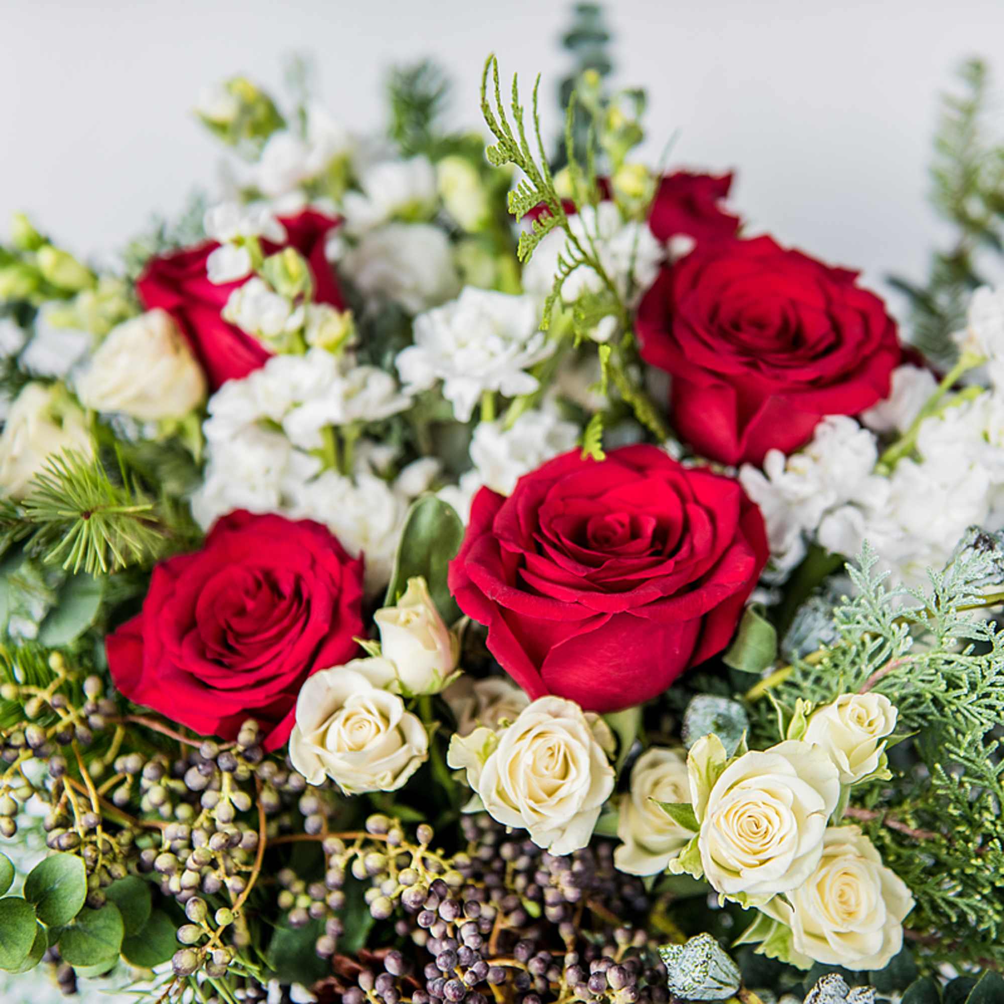 Celebrate the holidays with our Seasonal Holiday Arrangement, a lush mix of