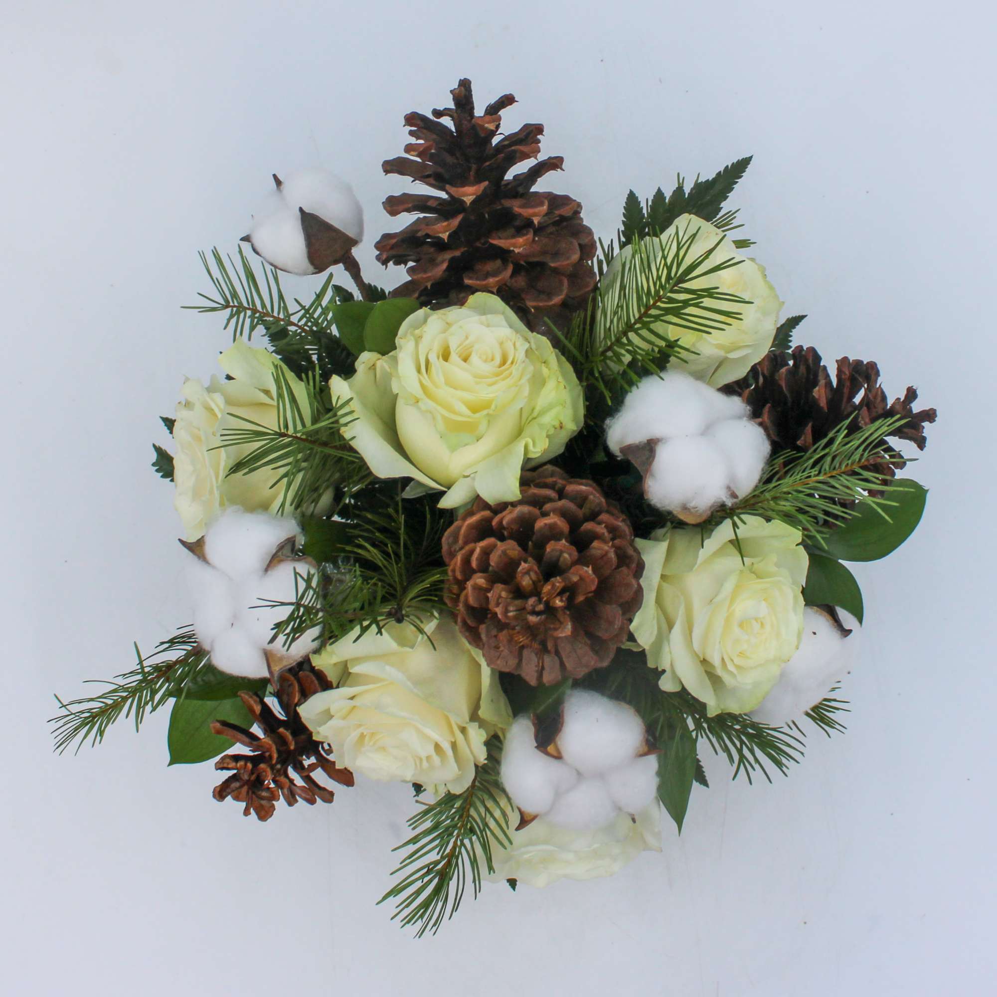 Aspen is a wintery mix of White Roses, Pinecones and Snow puffs
