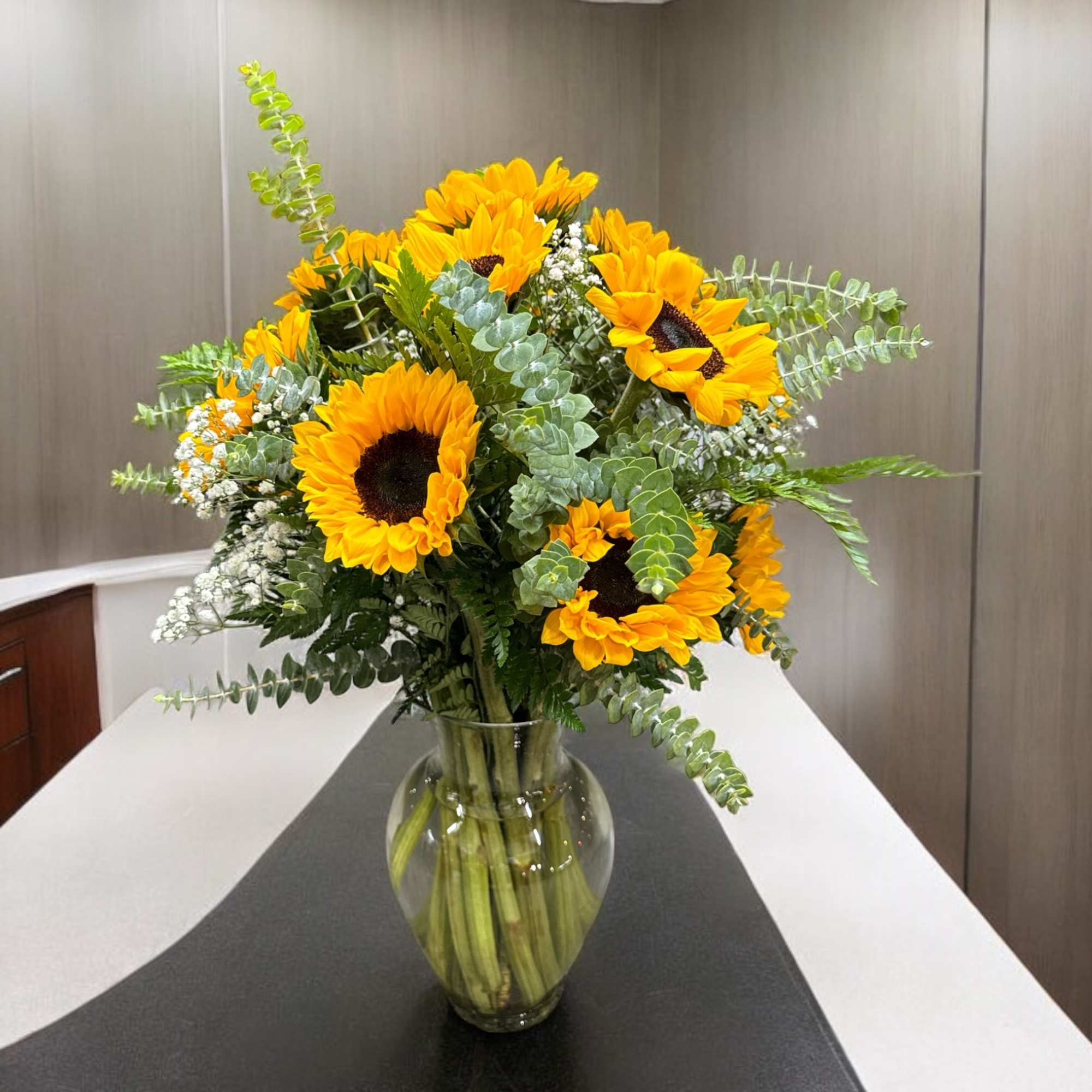 Beautiful spectacular sunflowers along with baby breath or just greens and some