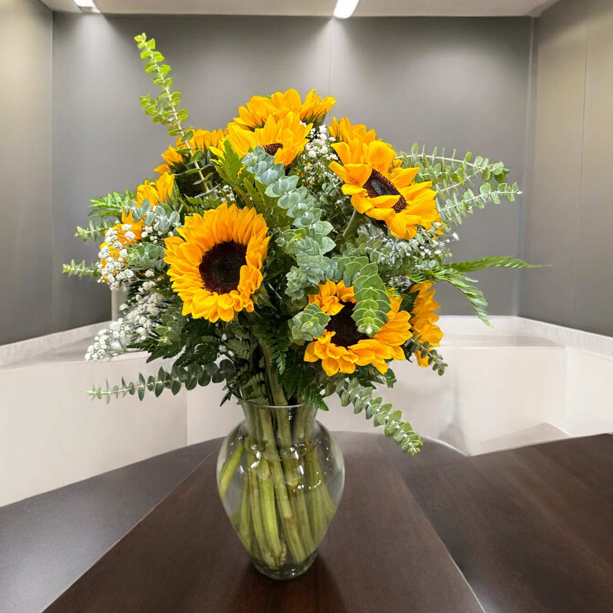 Beautiful spectacular sunflowers along with baby breath or just greens and some