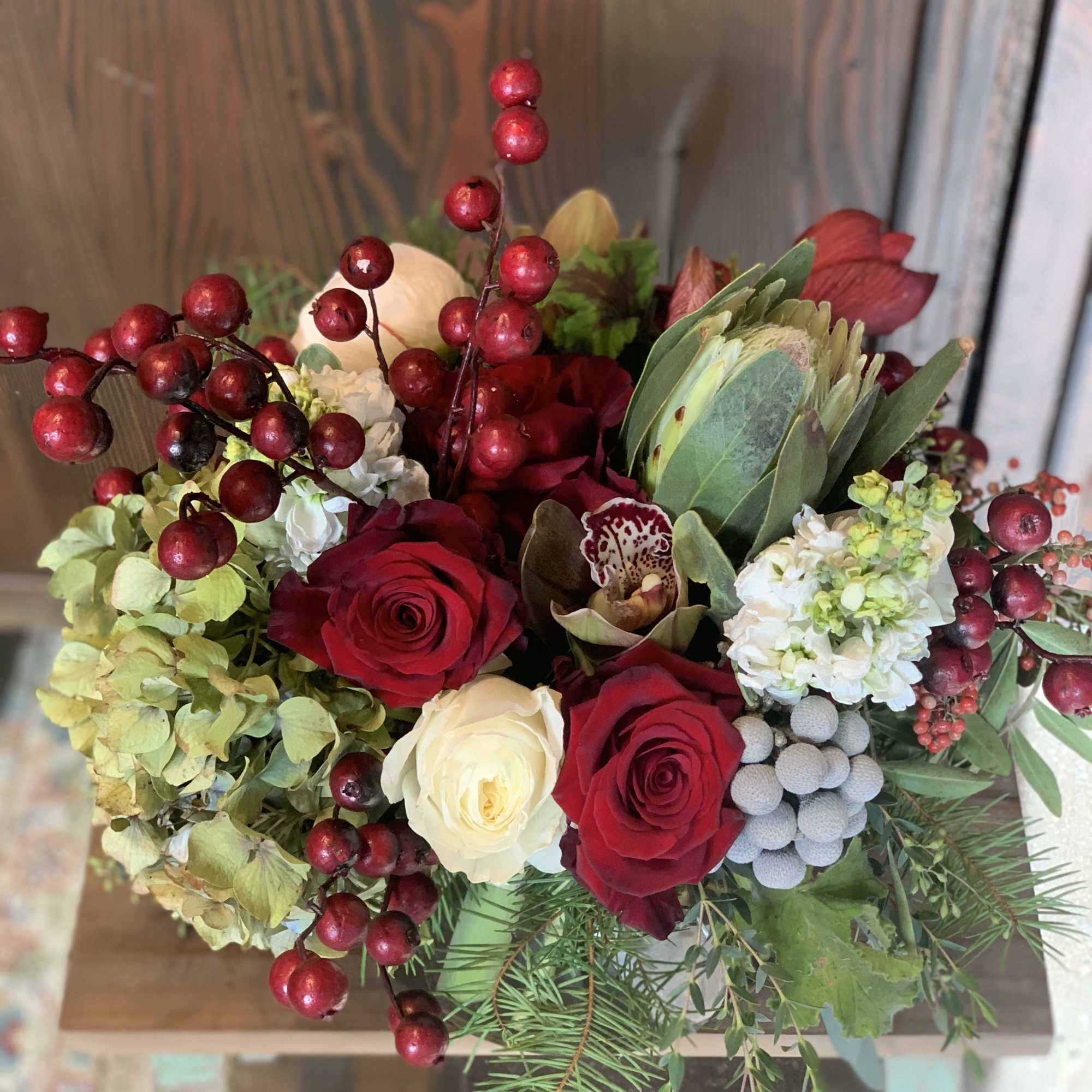 Traditional Christmas mix featuring hydrangeas, roses, berries and evergreens. 
Fresh and lively