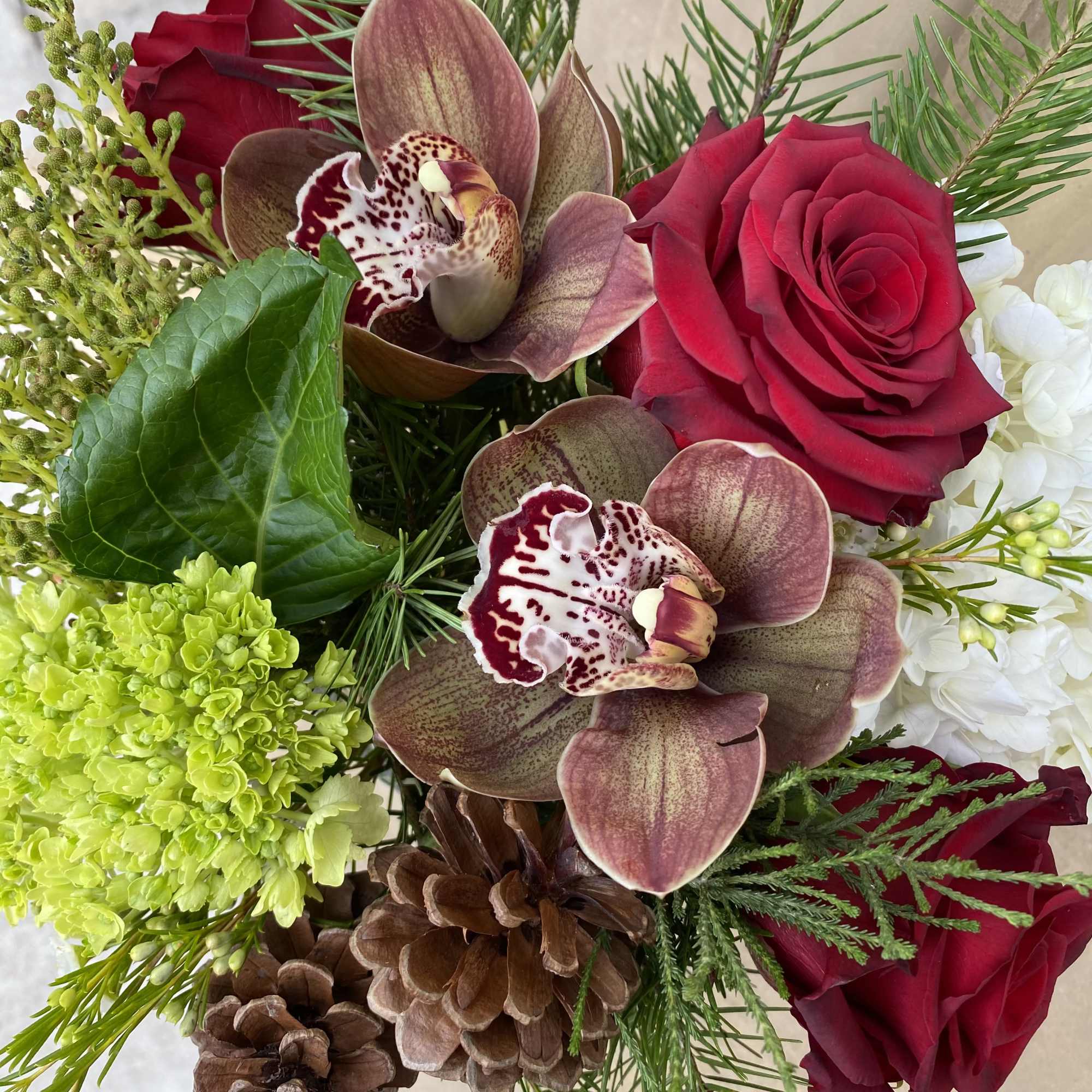 Traditional Christmas mix featuring hydrangeas, roses, berries and evergreens. 
Fresh and lively