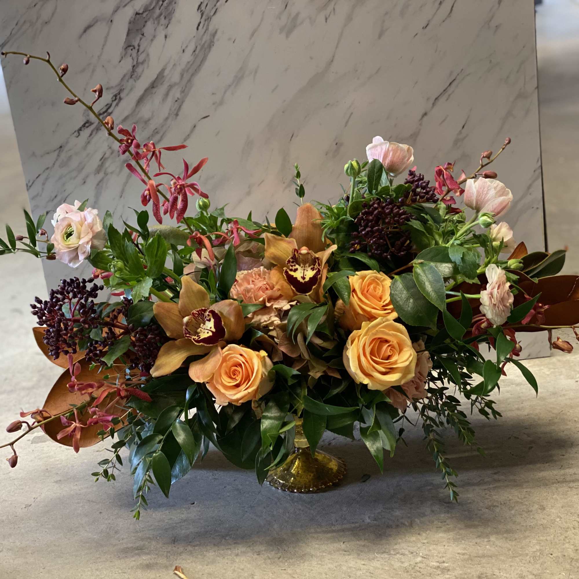 Elegant arrangement featuring sophisticated blooms in a cascading composition with sweeping gestures.