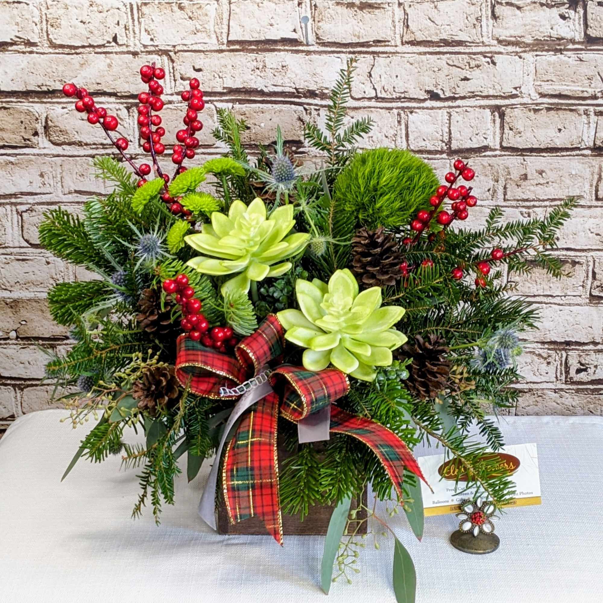 This festive arrangement is a cheerful celebration of winter charm and holiday