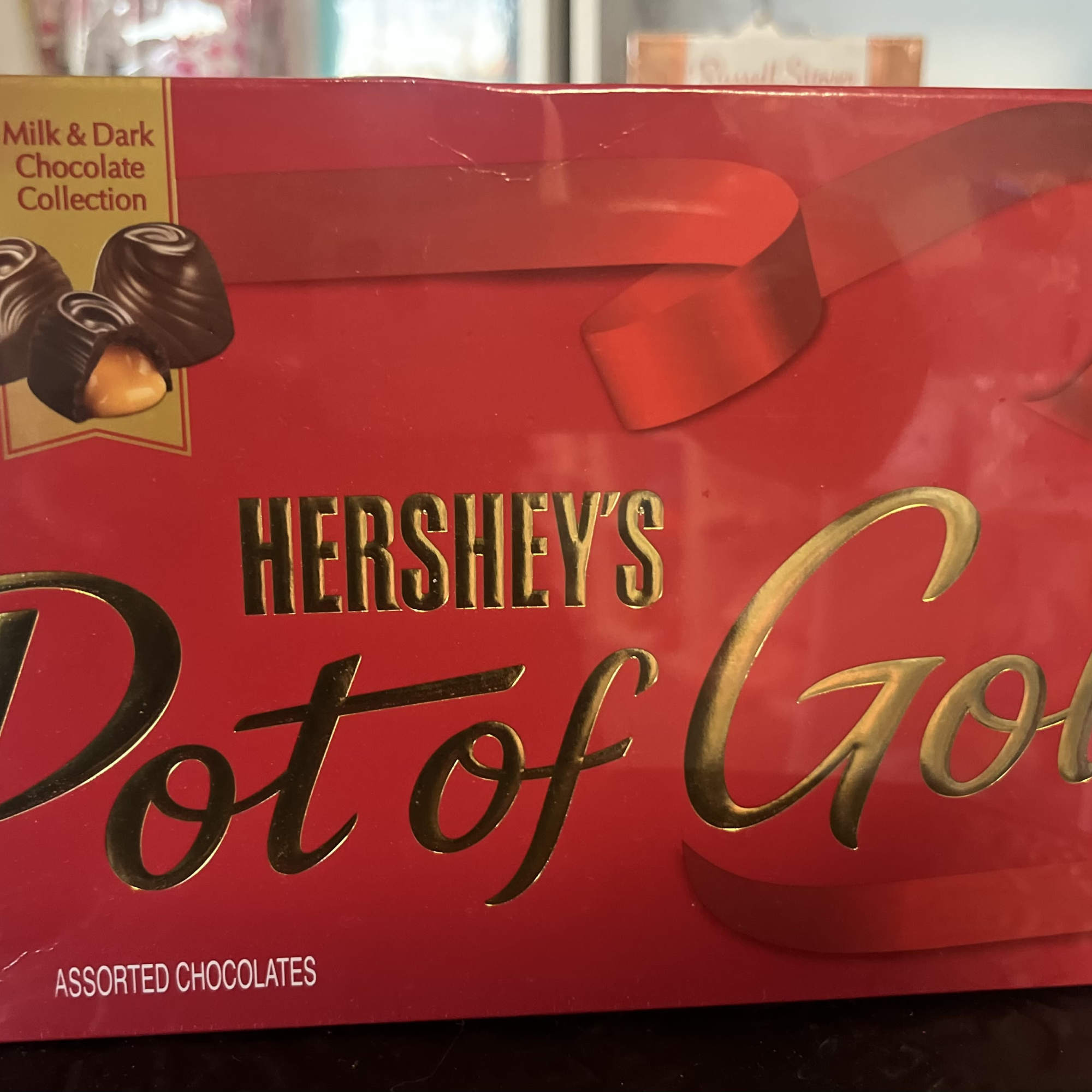 box of Hersheys chocolate with 12 roses in vase 