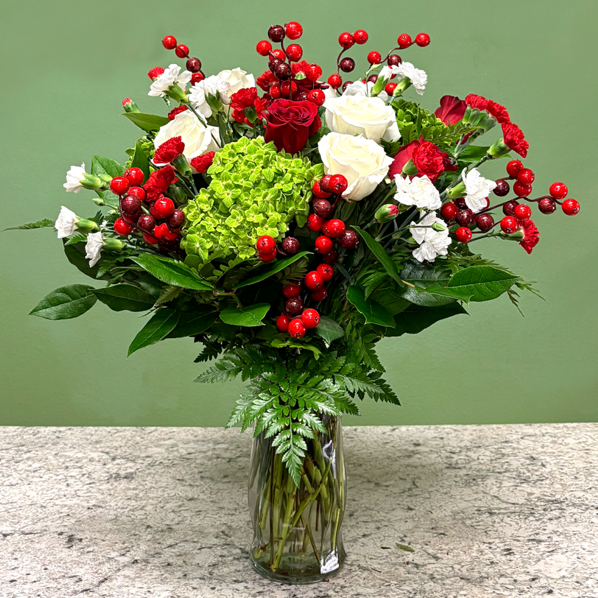 A mixed arrangement that celebrates the holiday spirit, showcasing a red, white