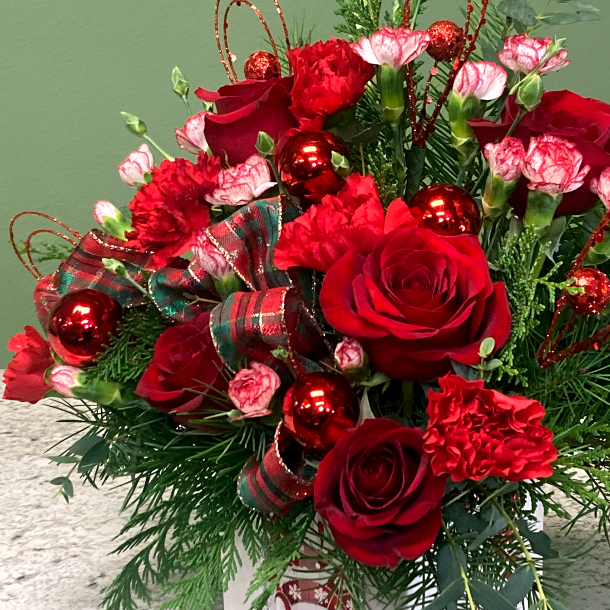 Wrap them in love with this holiday mixed arrangement! Lush red Roses