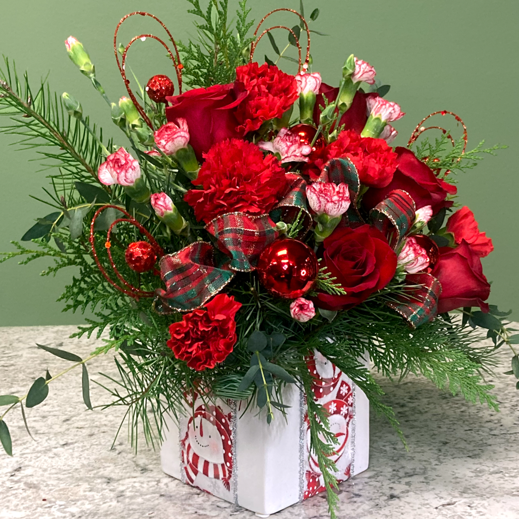 Wrap them in love with this holiday mixed arrangement! Lush red Roses