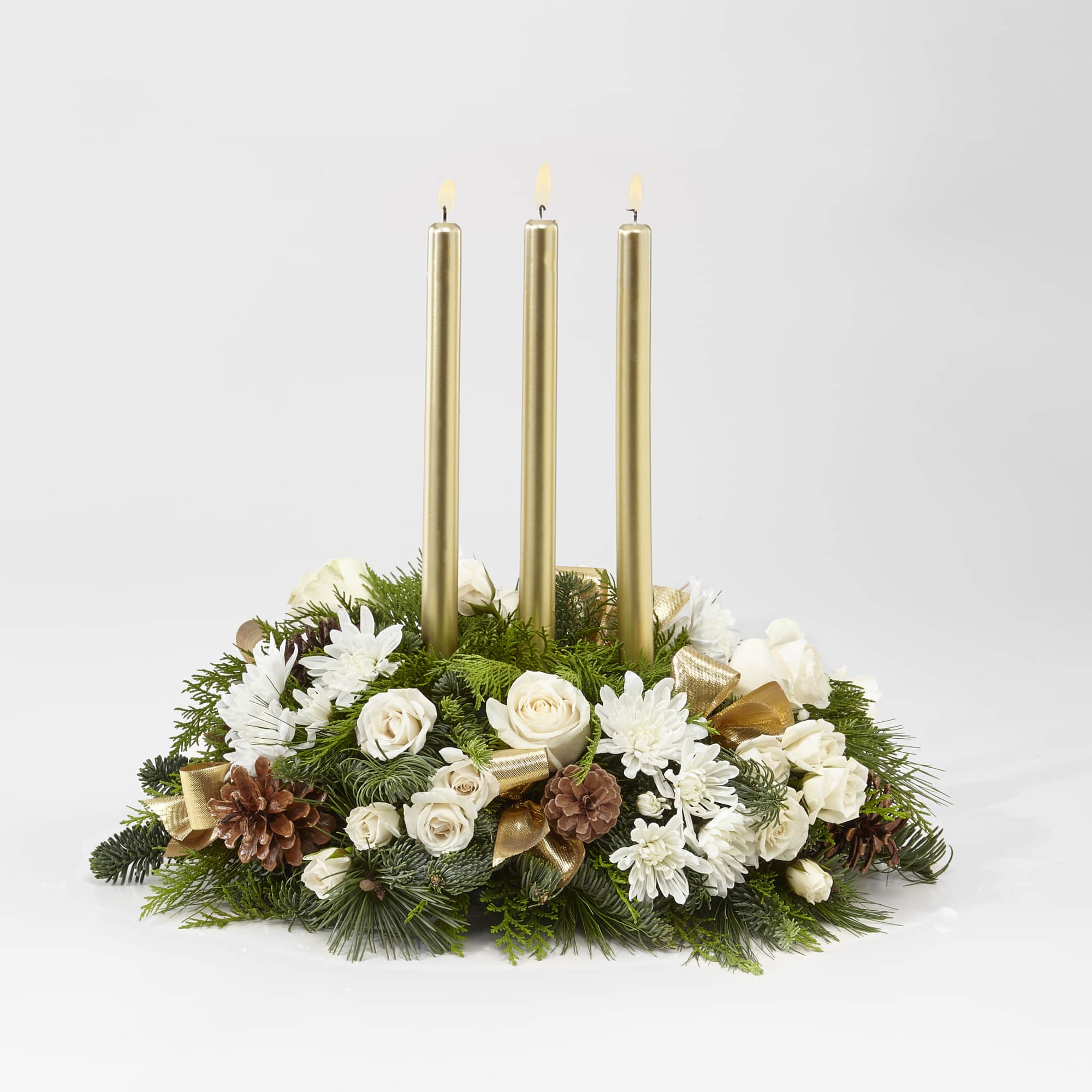 This golden and ivory centerpiece dotted with roses, mums, pinecones, and more