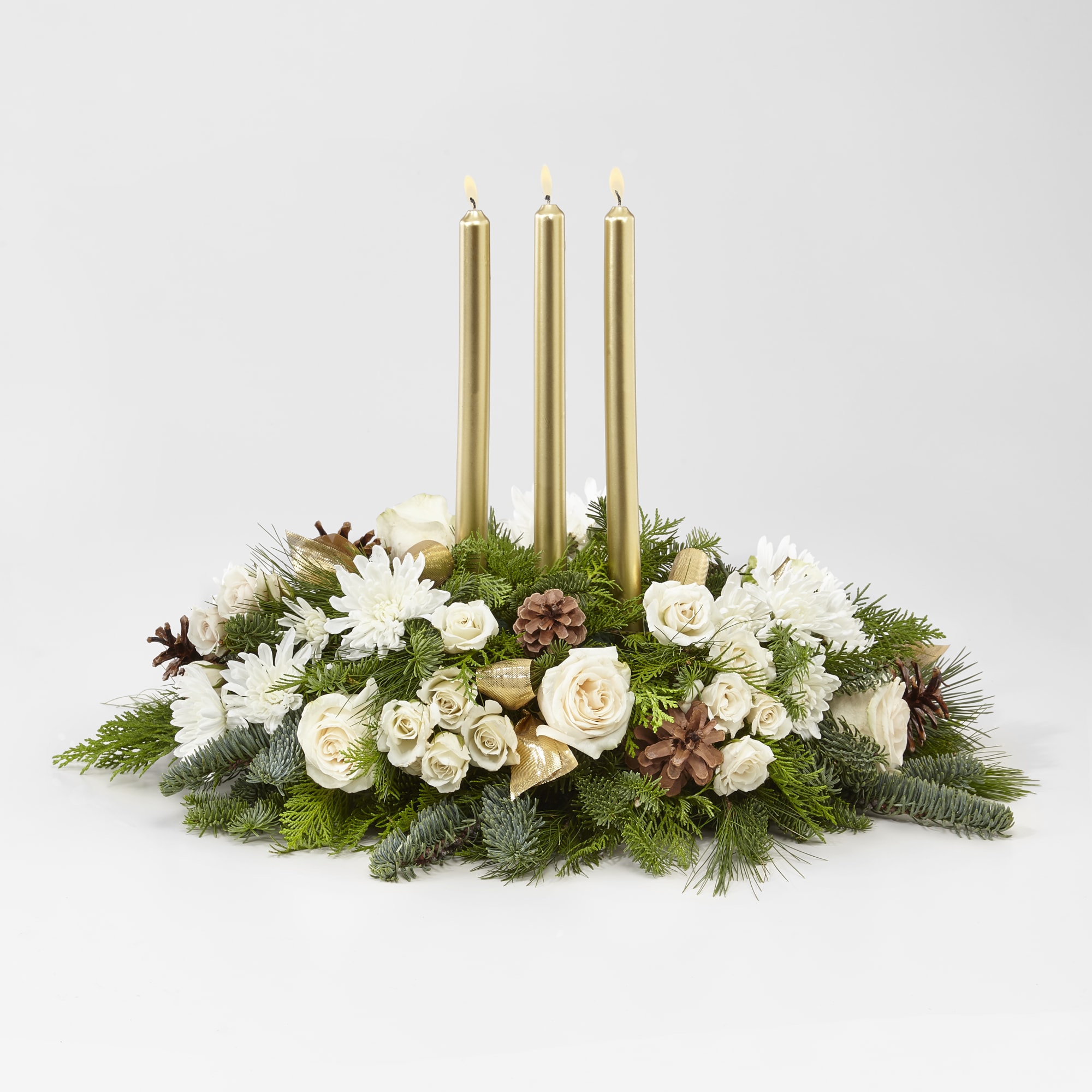 This golden and ivory centerpiece dotted with roses, mums, pinecones, and more