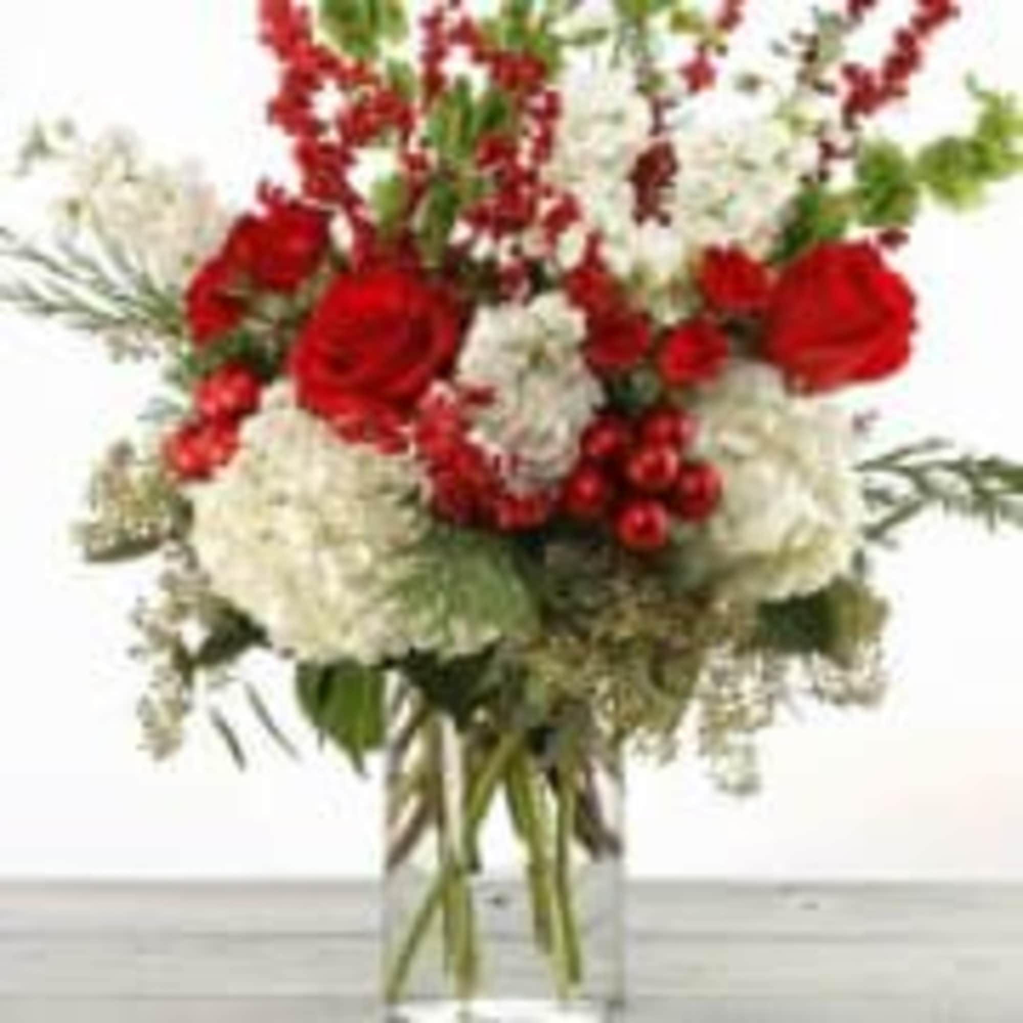 classic tall Christmas arrangement with Christmas greenery and white / red flowers