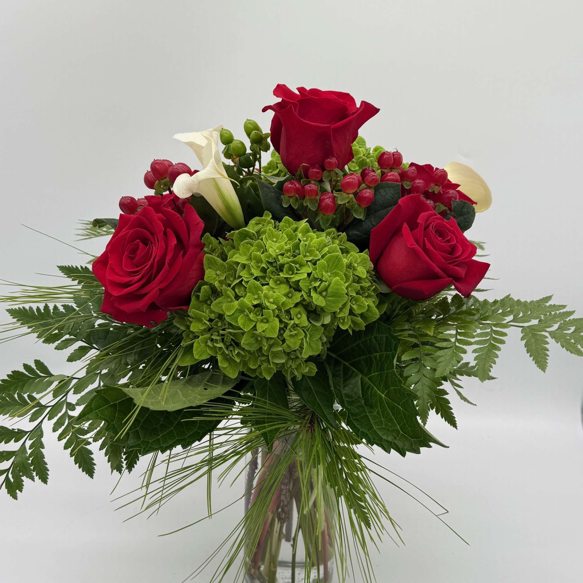 Sweet Scarlet is a lovely blend of bold red roses, soft green