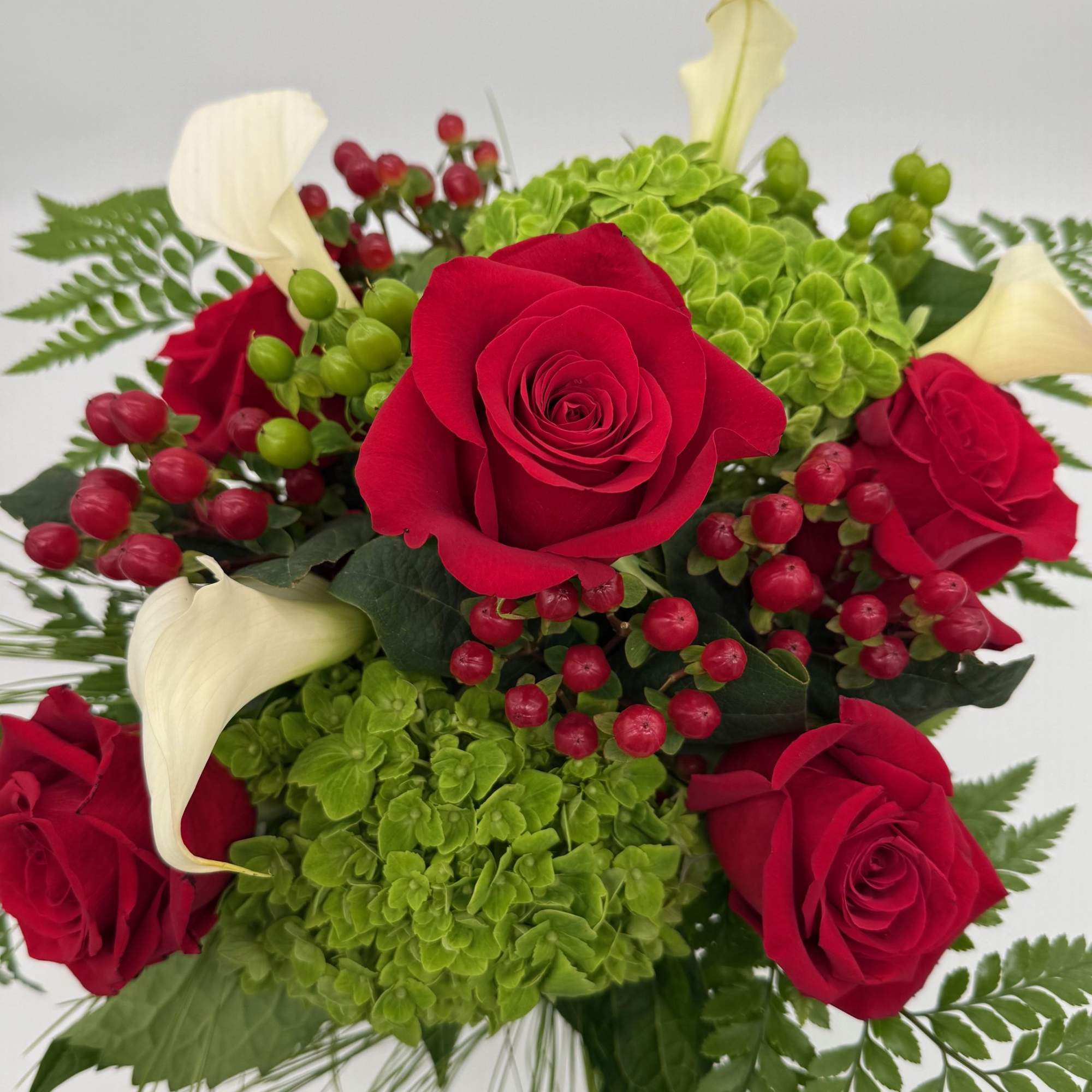 Sweet Scarlet is a lovely blend of bold red roses, soft green