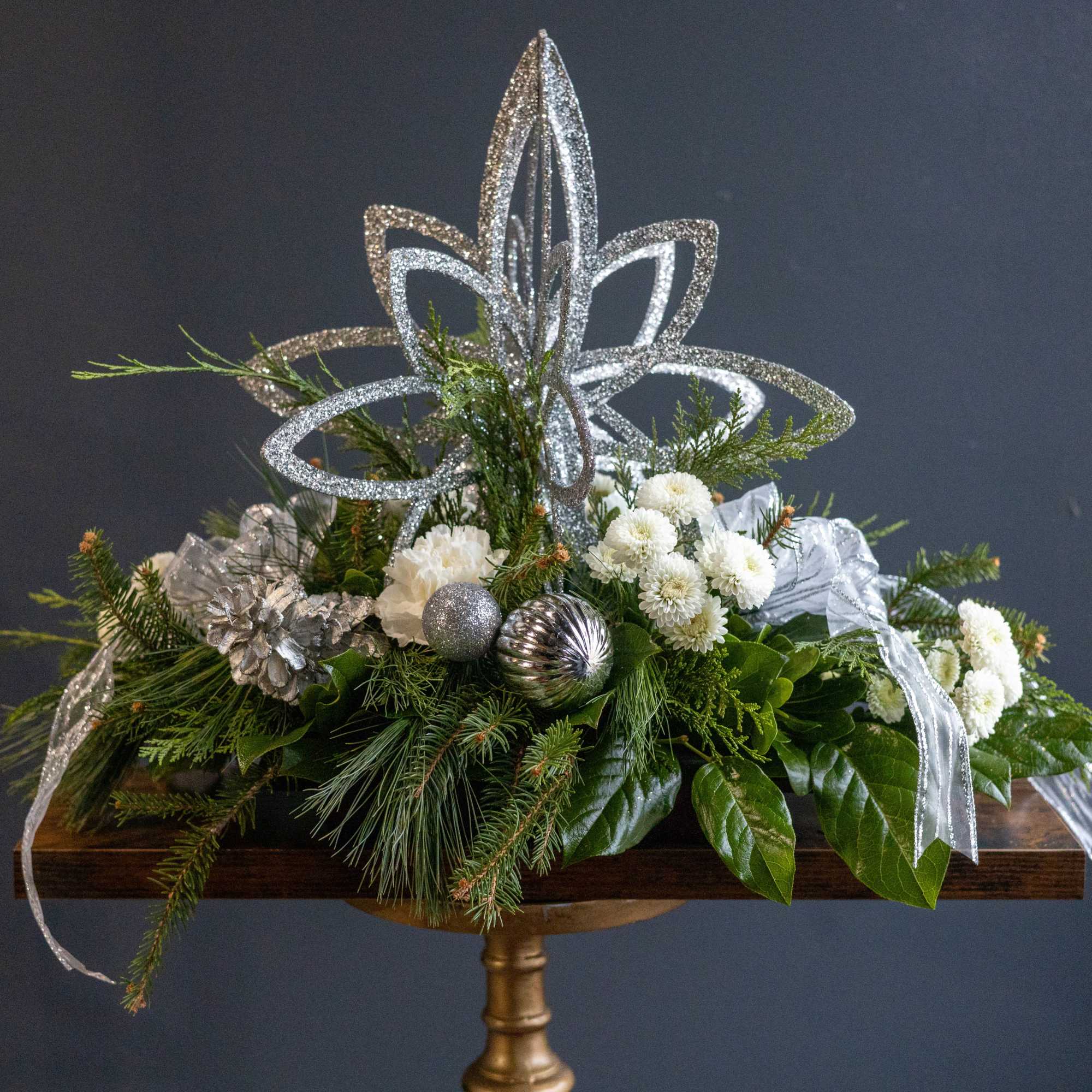 Shining Star is an elegant winter arrangement designed to bring a sense