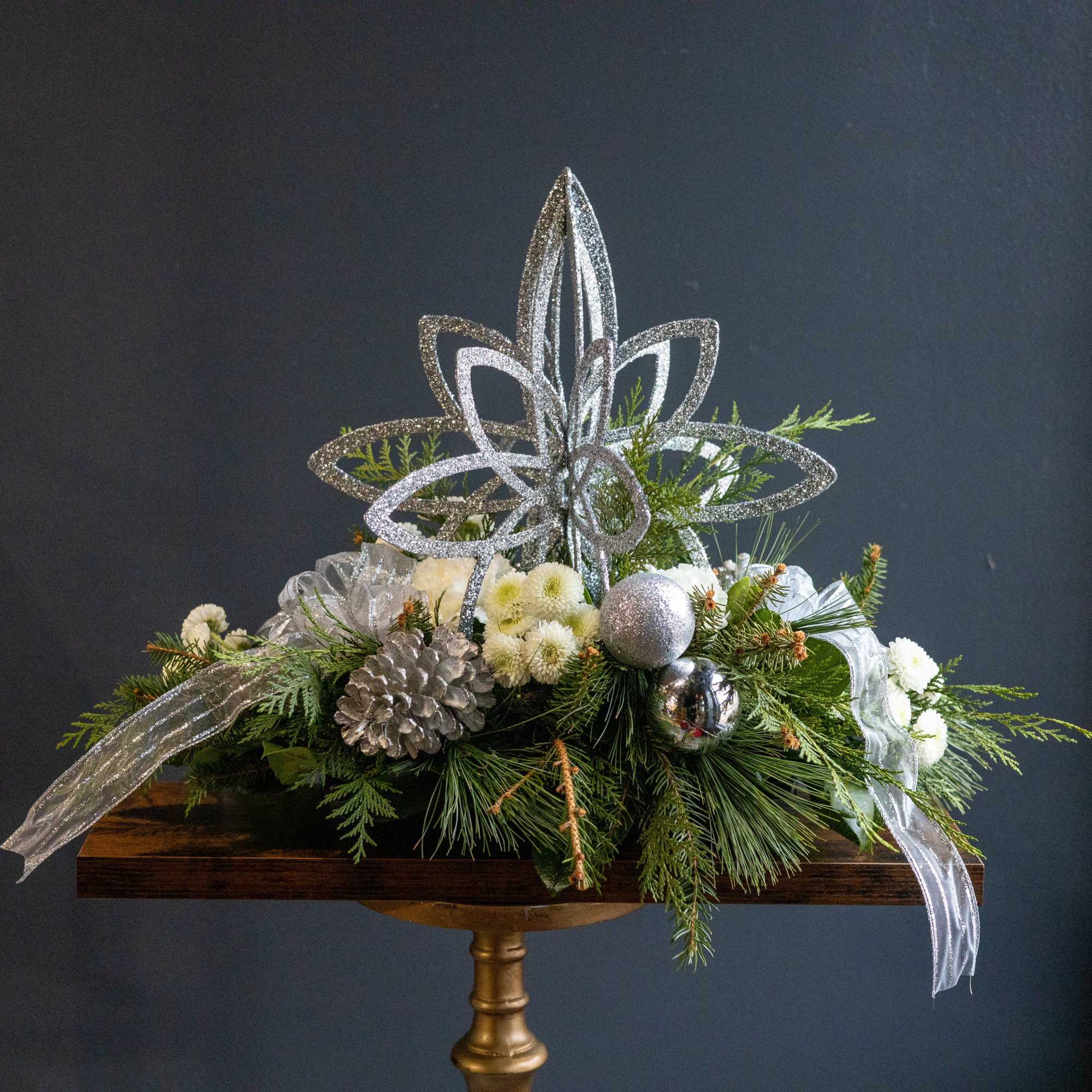 Shining Star is an elegant winter arrangement designed to bring a sense