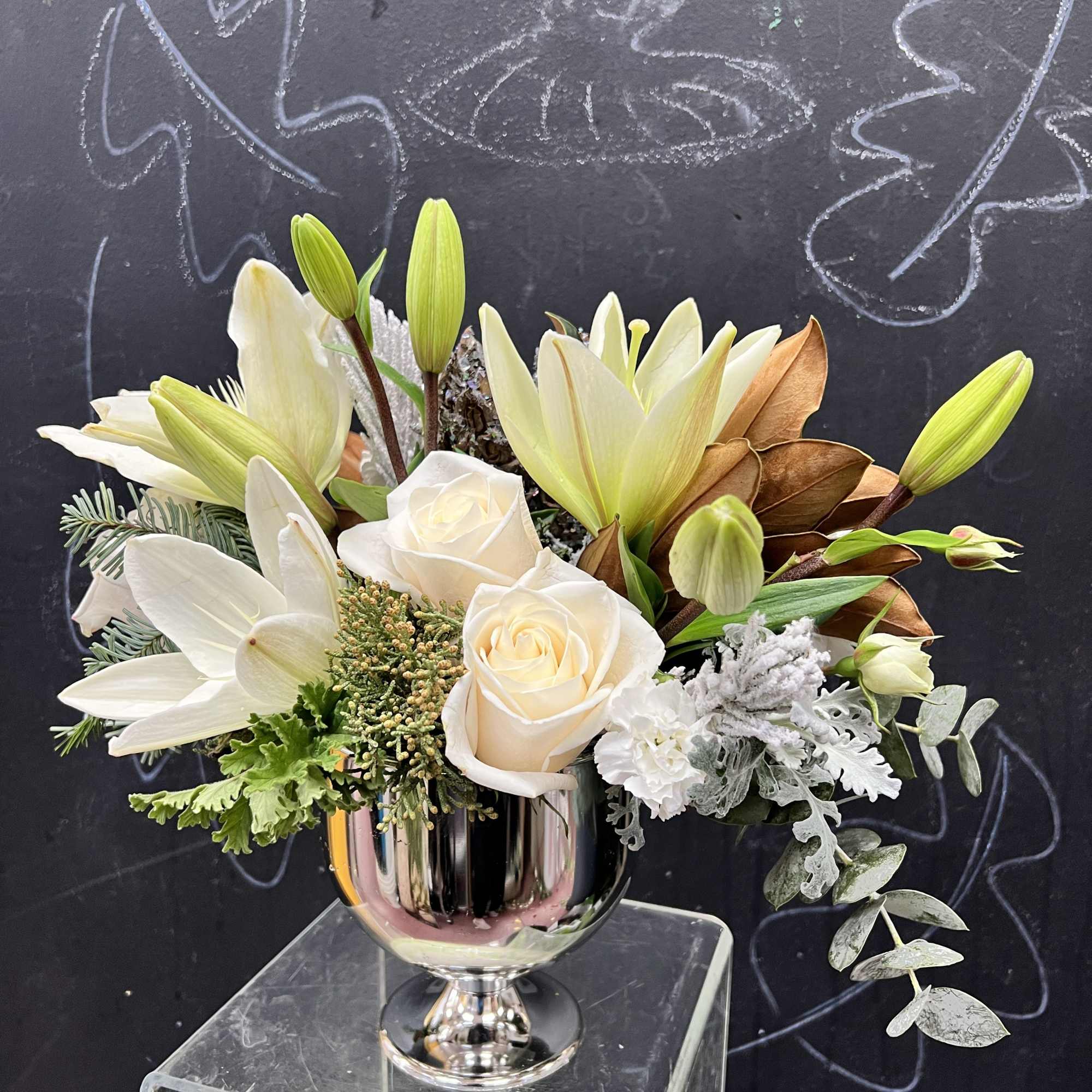 Winter greens and snow white blooms are paired to perfection in a