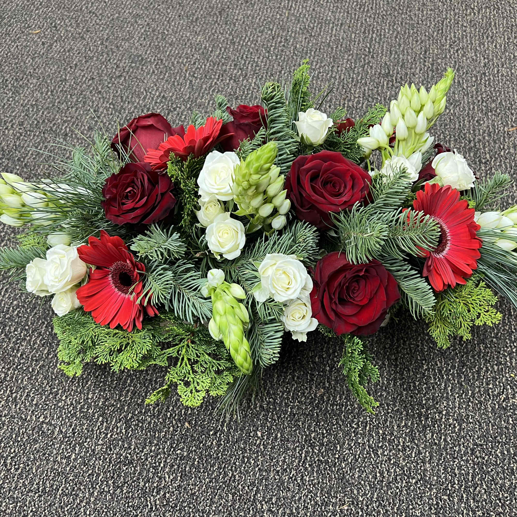 Beautiful Holiday long, low centerpiece in a 12" birch box. Includes roses