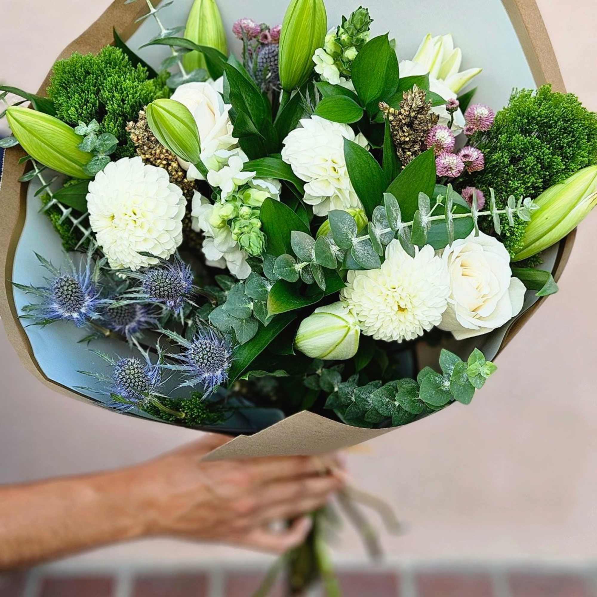 This bouquet has a fresh, elegant, garden-inspired feel with a soft, natural