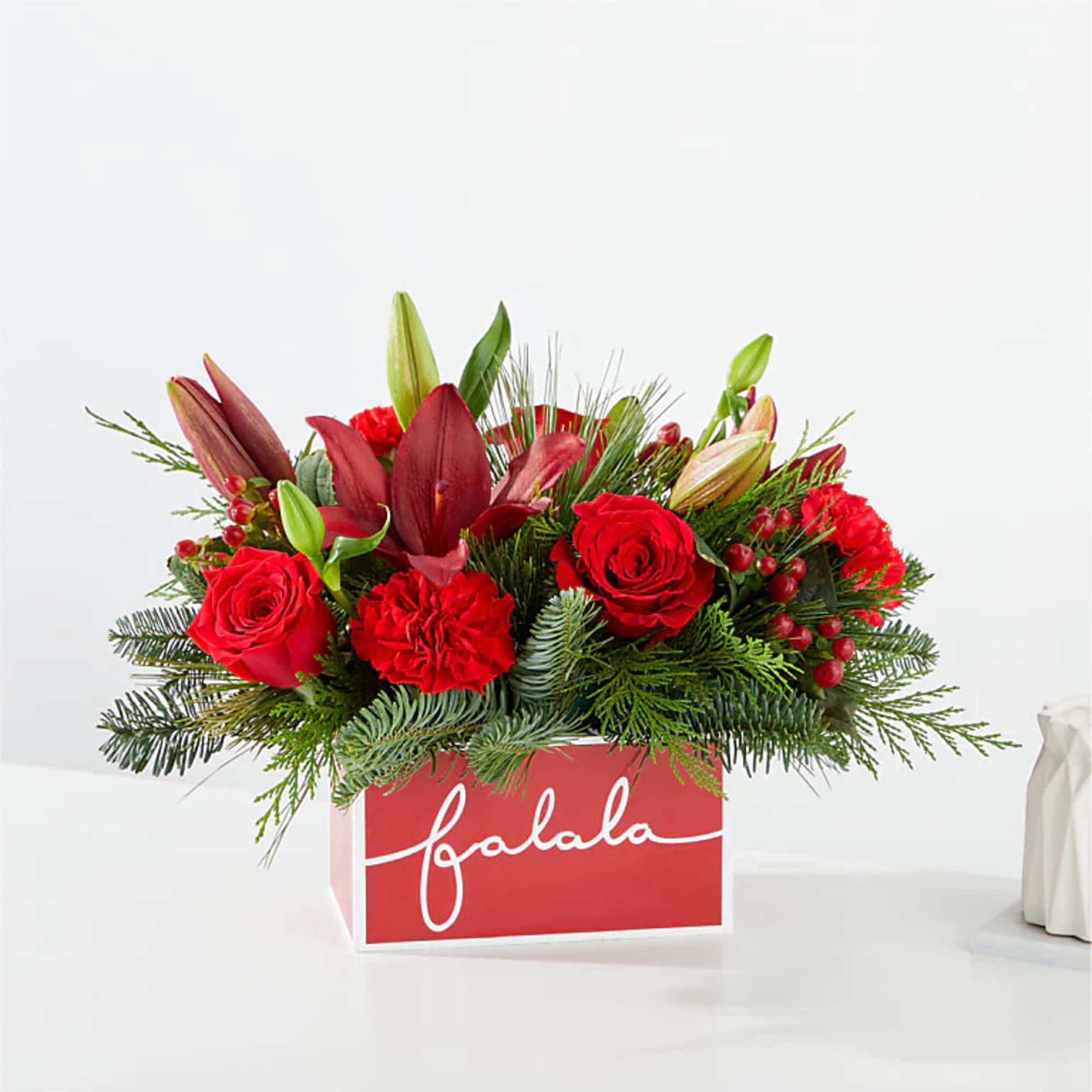 Deck their halls with this lively bouquet studded with eye catching red