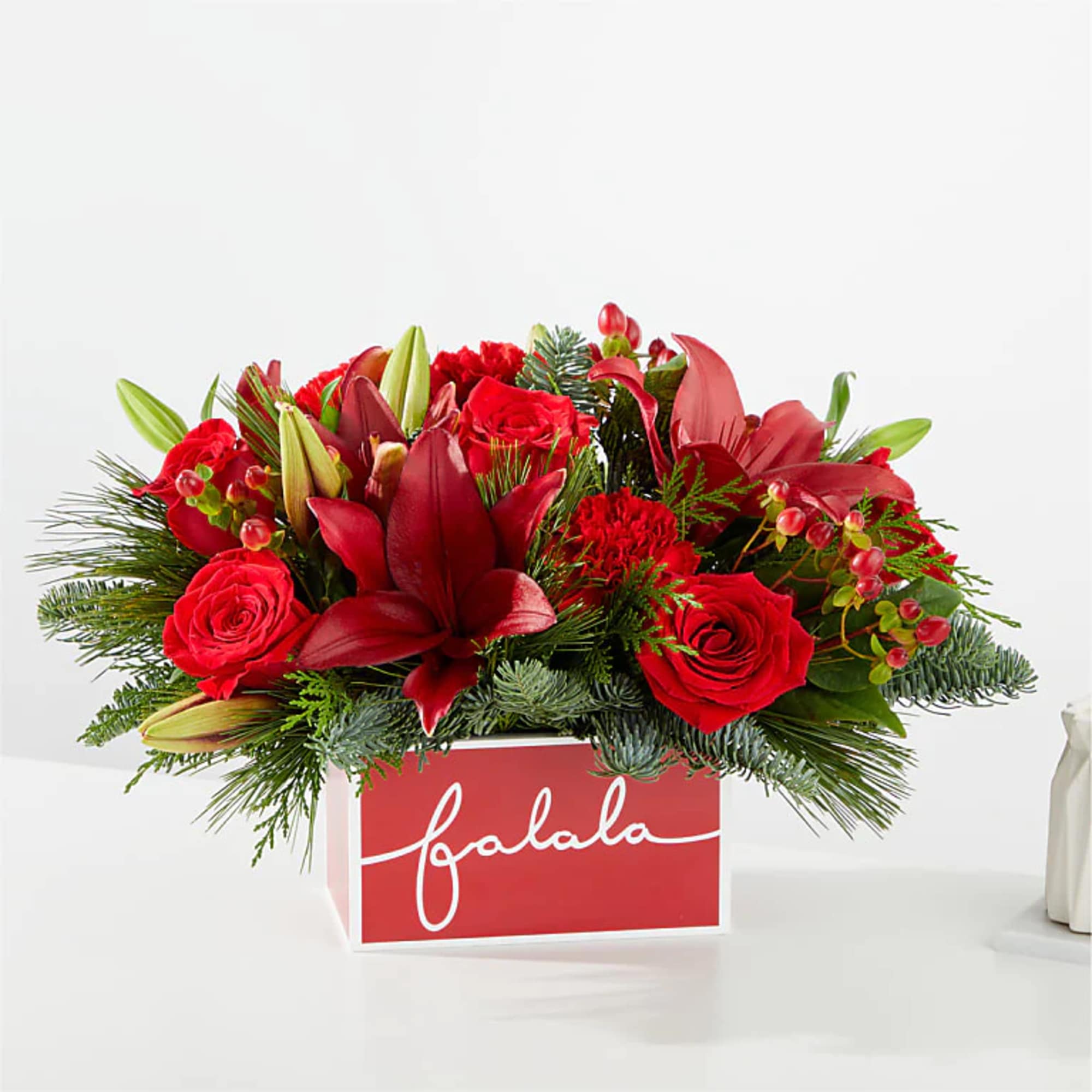 Deck their halls with this lively bouquet studded with eye catching red