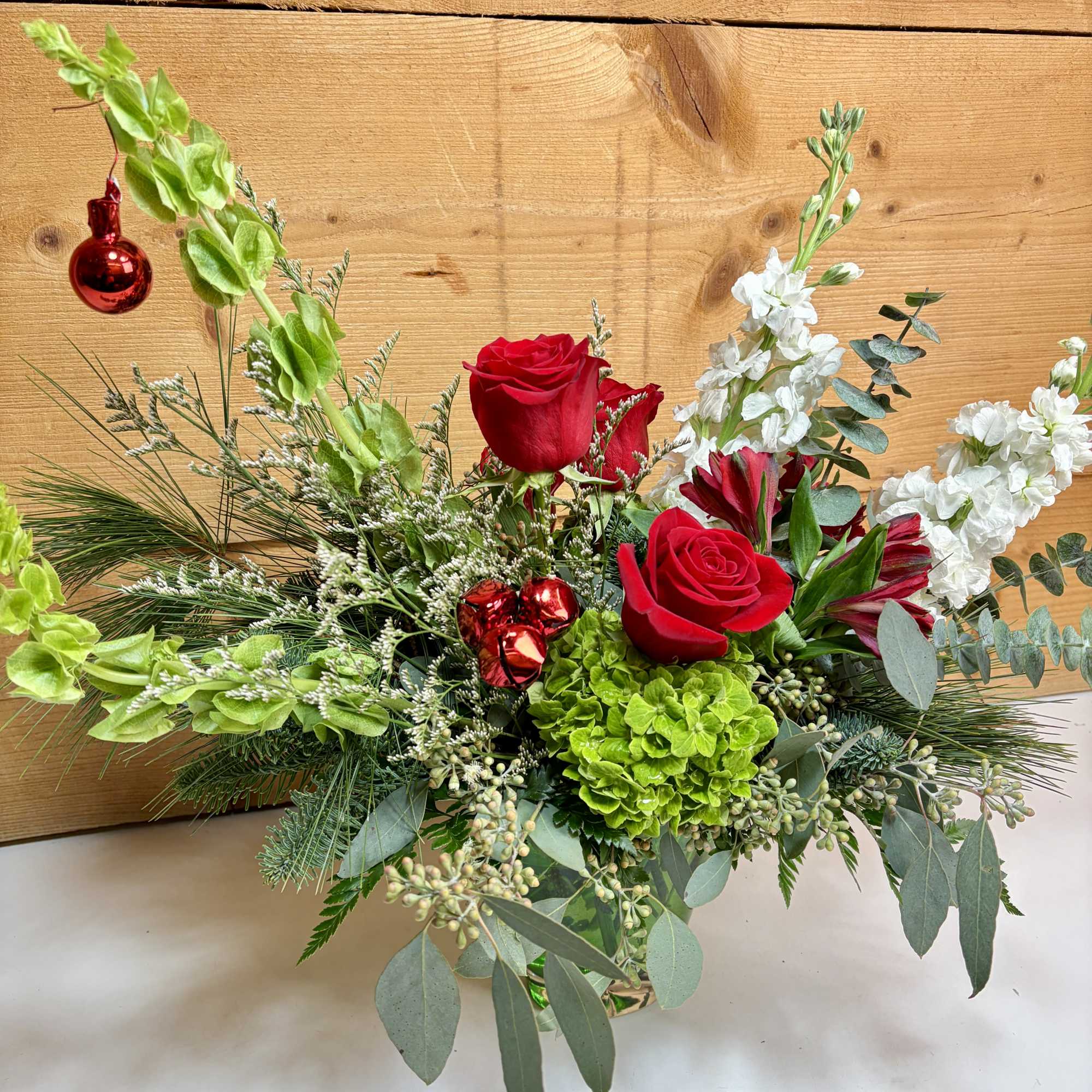 Feelin&rsquo; Grinchy blends bold pops of Grinch-green hydrangea with classic red roses